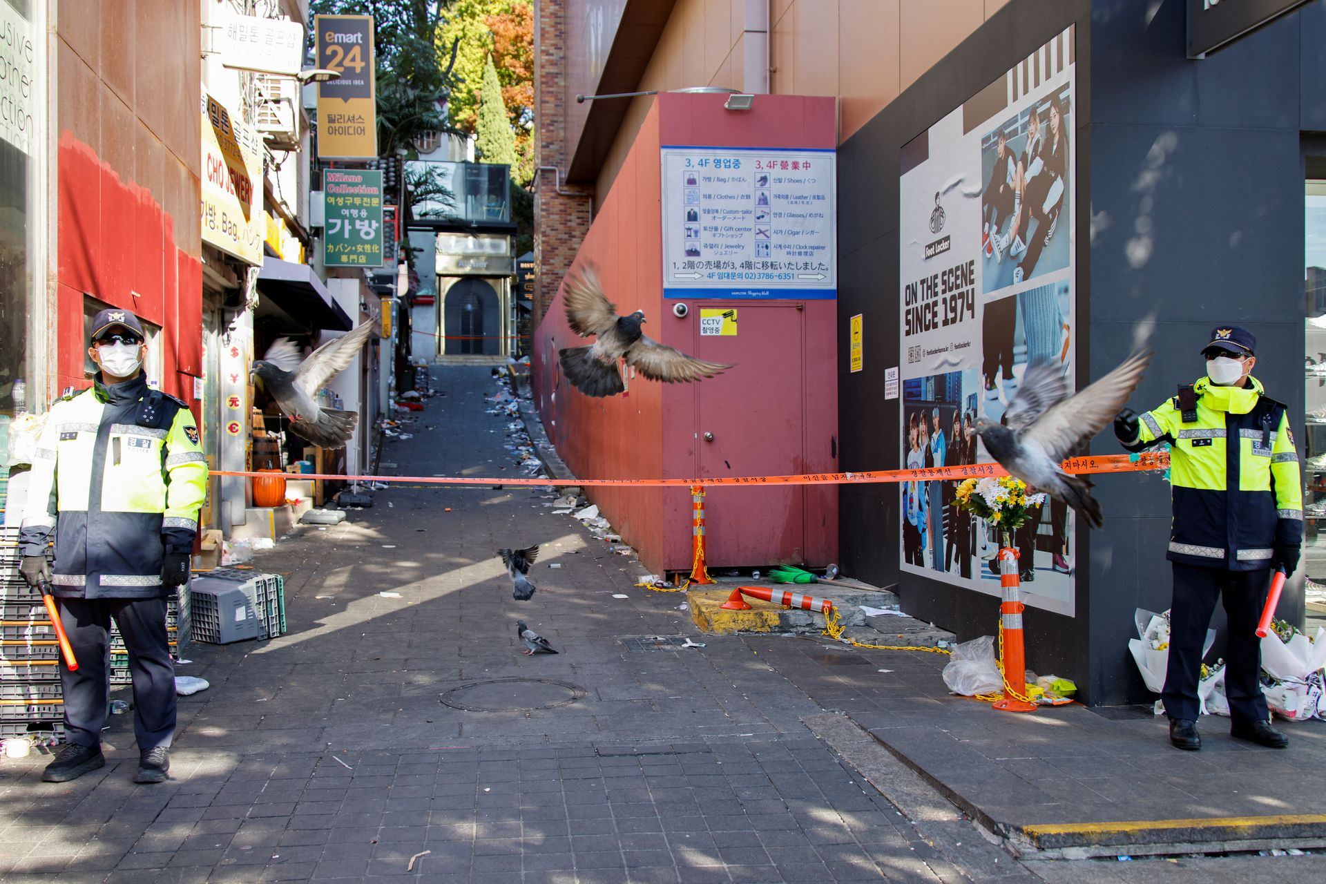 Police officers stand guard near the scene of a crowd crush that happened during Halloween festivities, in Seoul, South Korea, Nov. 2, 2022.