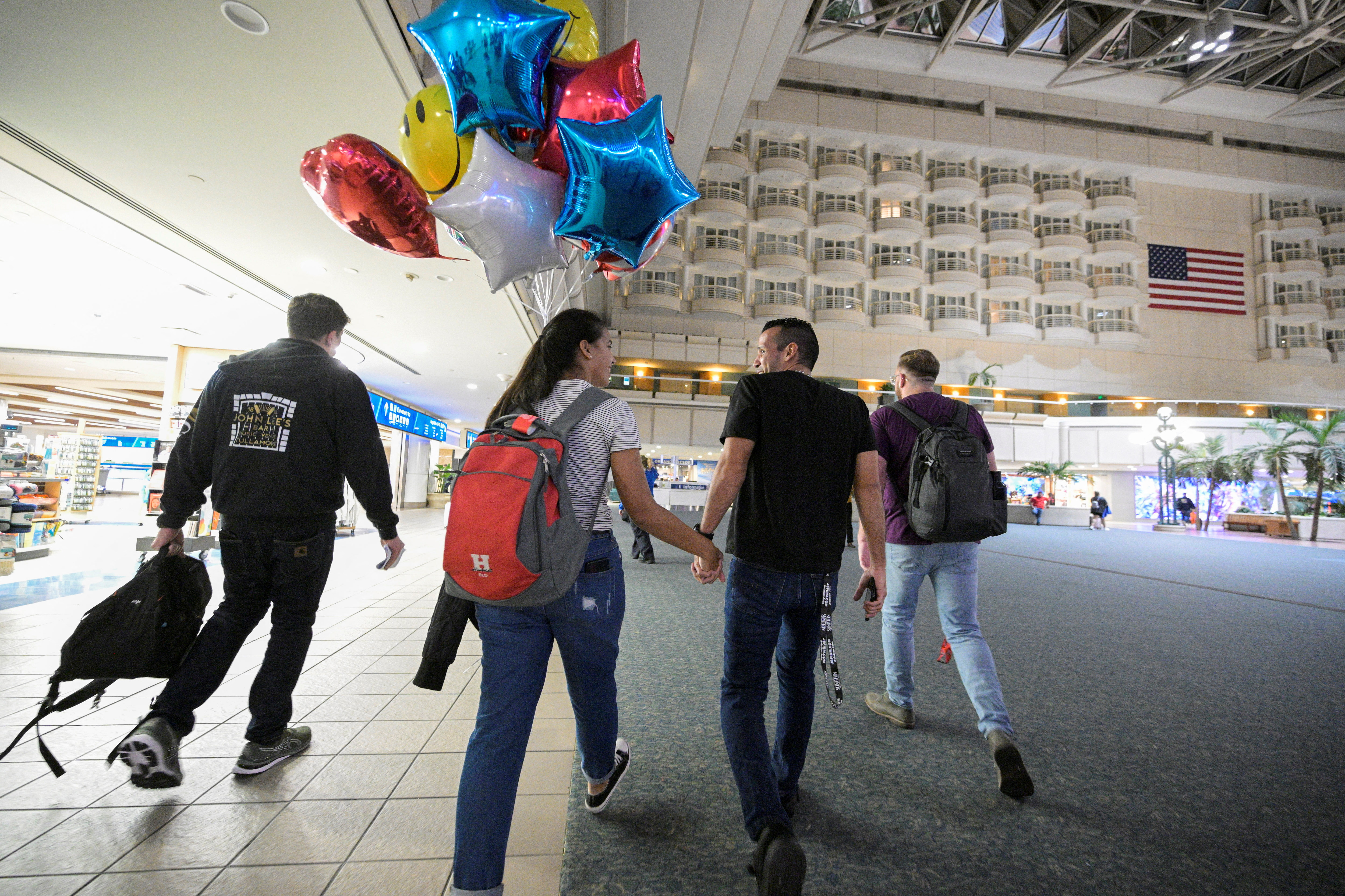 Venezuelan Victoriana Loaiza walks through Orlando International Airport after reuniting with her partner Jhonny Rosales, following her arrival from Mexico City in Orlando, Florida,  Oct. 31, 2022.