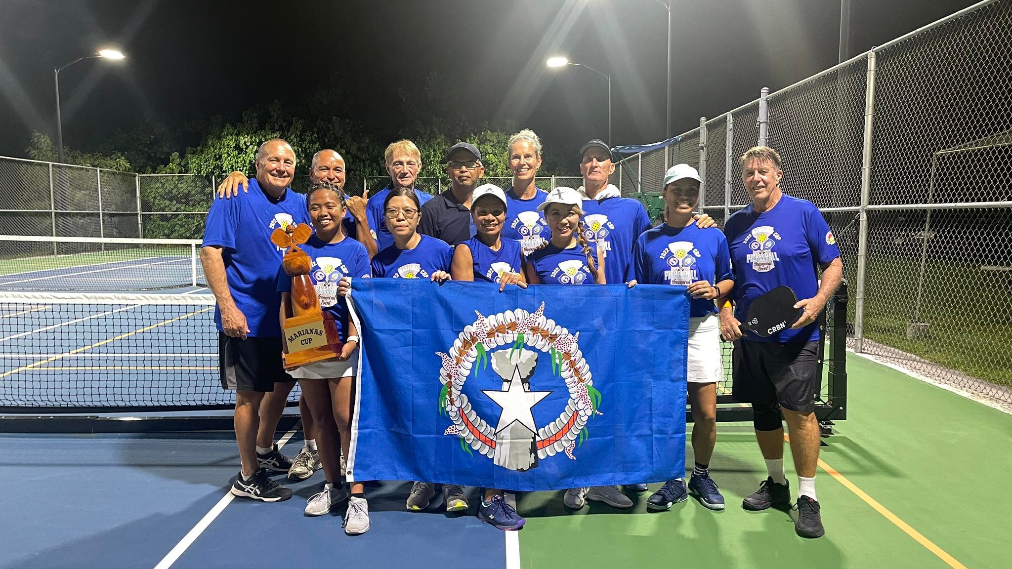 Team Saipan members display the CNMI flag and the Marianas Cup after winning the inaugural Marianas Cup Pickleball Tournament at  American Memorial Park on Saturday.Contributed photo