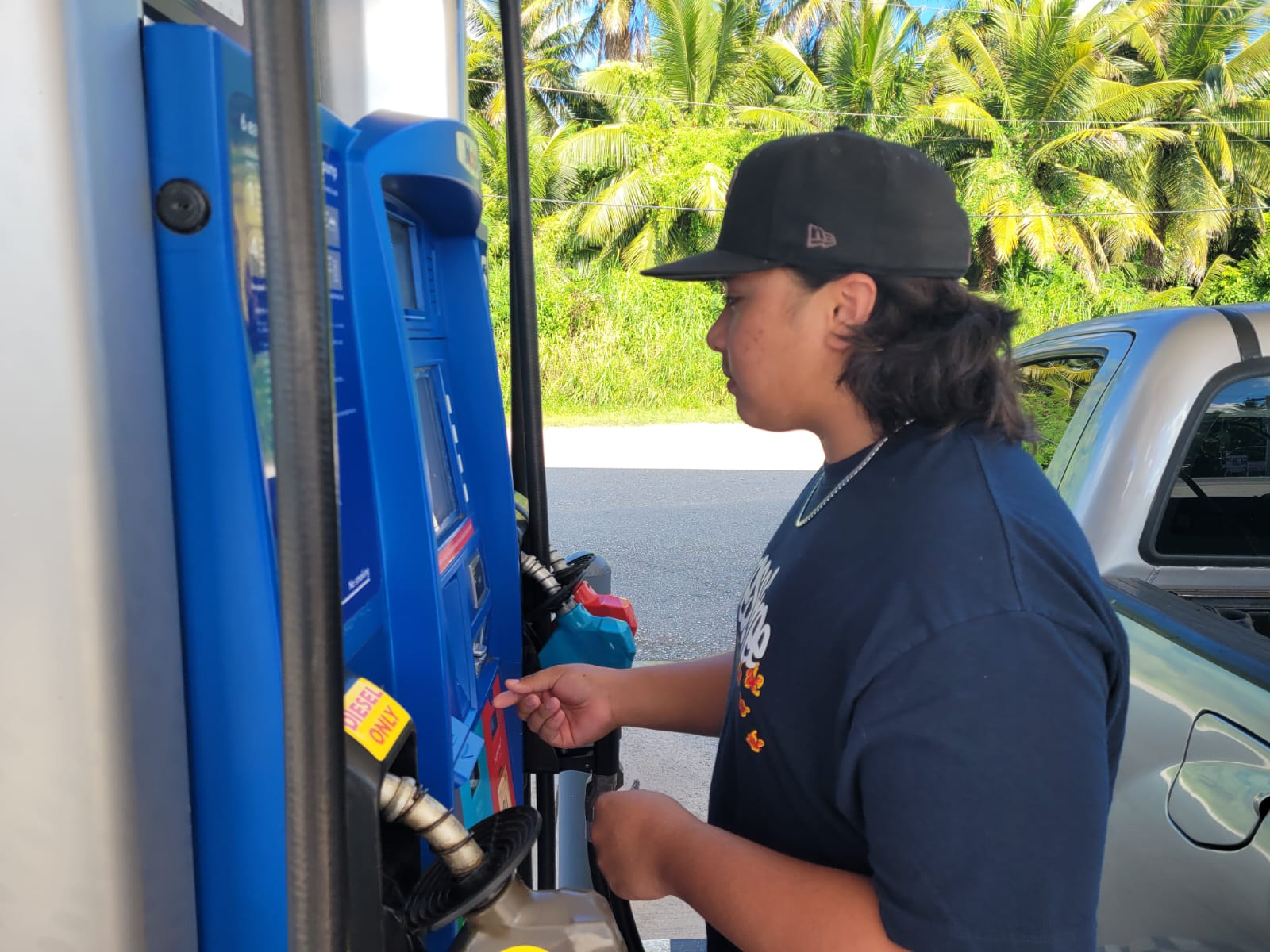 Northern Marianas College student Christopher Pangelinan purchases gasoline at the Chalan Kiya service station on Wednesday