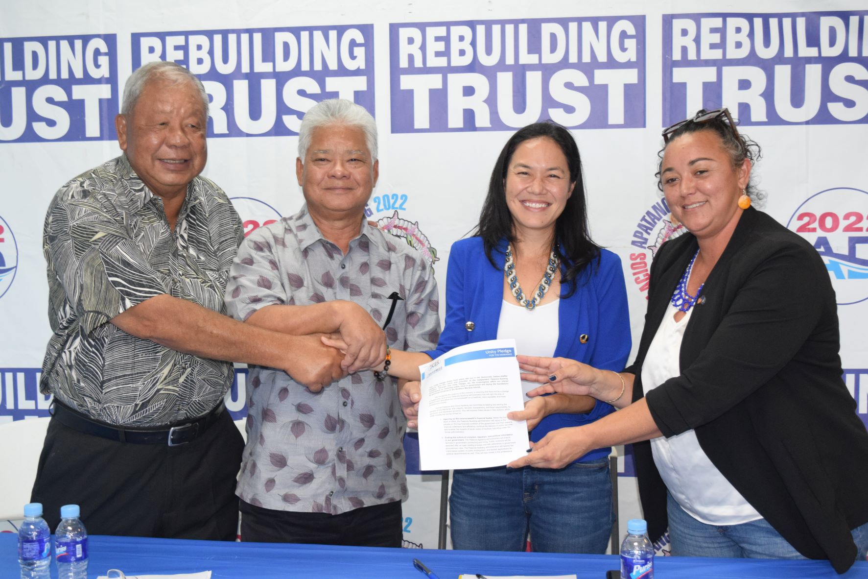 From left, Saipan Mayor David M. Apatang, Lt. Gov. Arnold I. Palacios, Reps. Tina Sablan and Leila F. Staffler hold a copy of their “Unity Pledge for the Marianas” during a press conference on Wednesday at the AD 2022 campaign headquarter in Garapan.