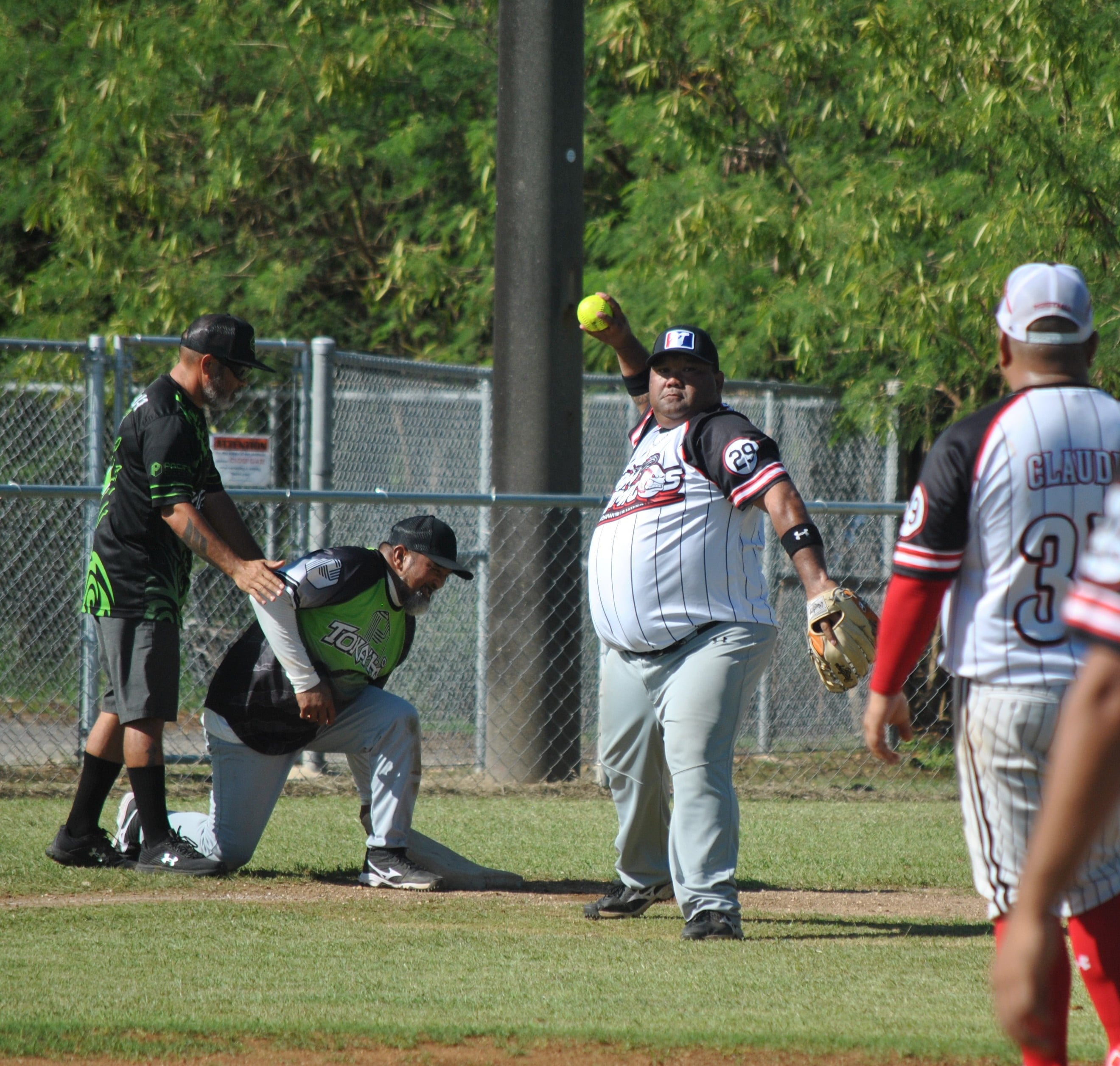 Man Amigos third baseman Manny Sablan throws the ball to the pitcher during a 2022 Budweiser Belau Amateur Softball League game at the Dandan baseball field.
