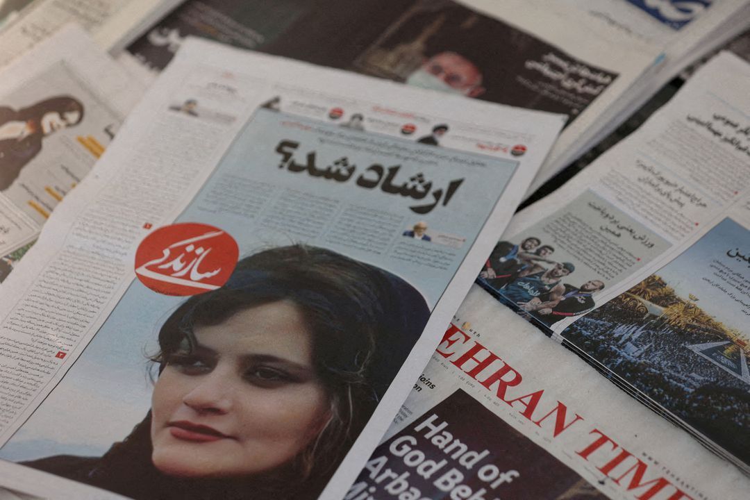 A newspaper with a cover picture of Mahsa Amini, who died after being arrested by Iranian morality police is seen in Tehran, Iran, Sept. 18, 2022.