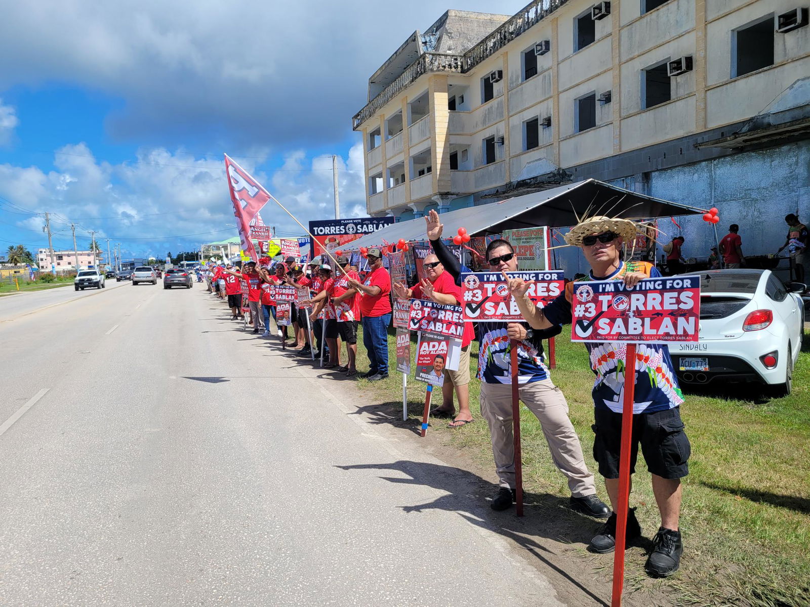 GOP supporters wave at motorists across from Hopwood Middle School on Tuesday