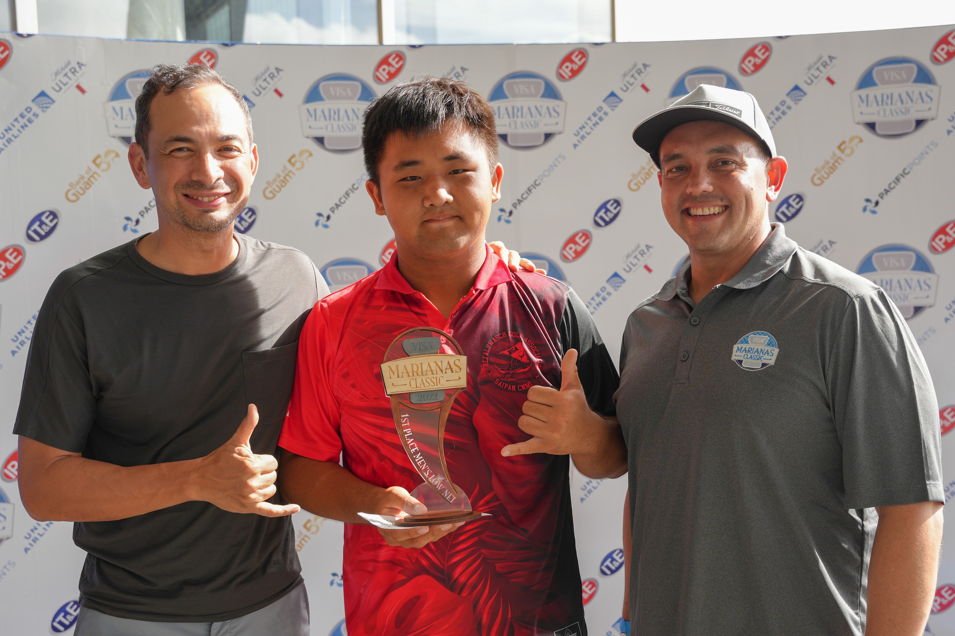 Zhi Yun Li, center, poses with Citadel Holdings CEO Ricky Delgado Jr., left,  and Bank of Guam President and CEO Joaquin Cook. Li topped the men's low gross category of the VISA Marianas Golf Classic at  Laolao Bay Golf & Resort on Saturday.
