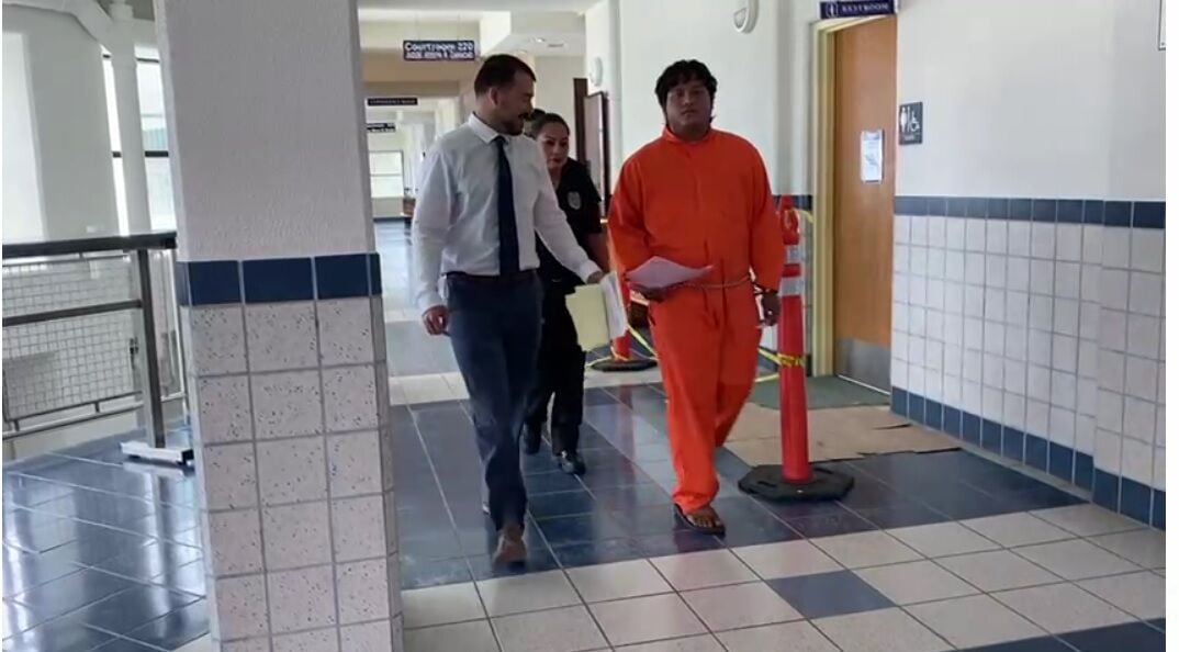 Tyneth Santos Mariur, right, with Assistant Public Defender Tyler Scott following a bail hearing in Superior Court on Monday. 