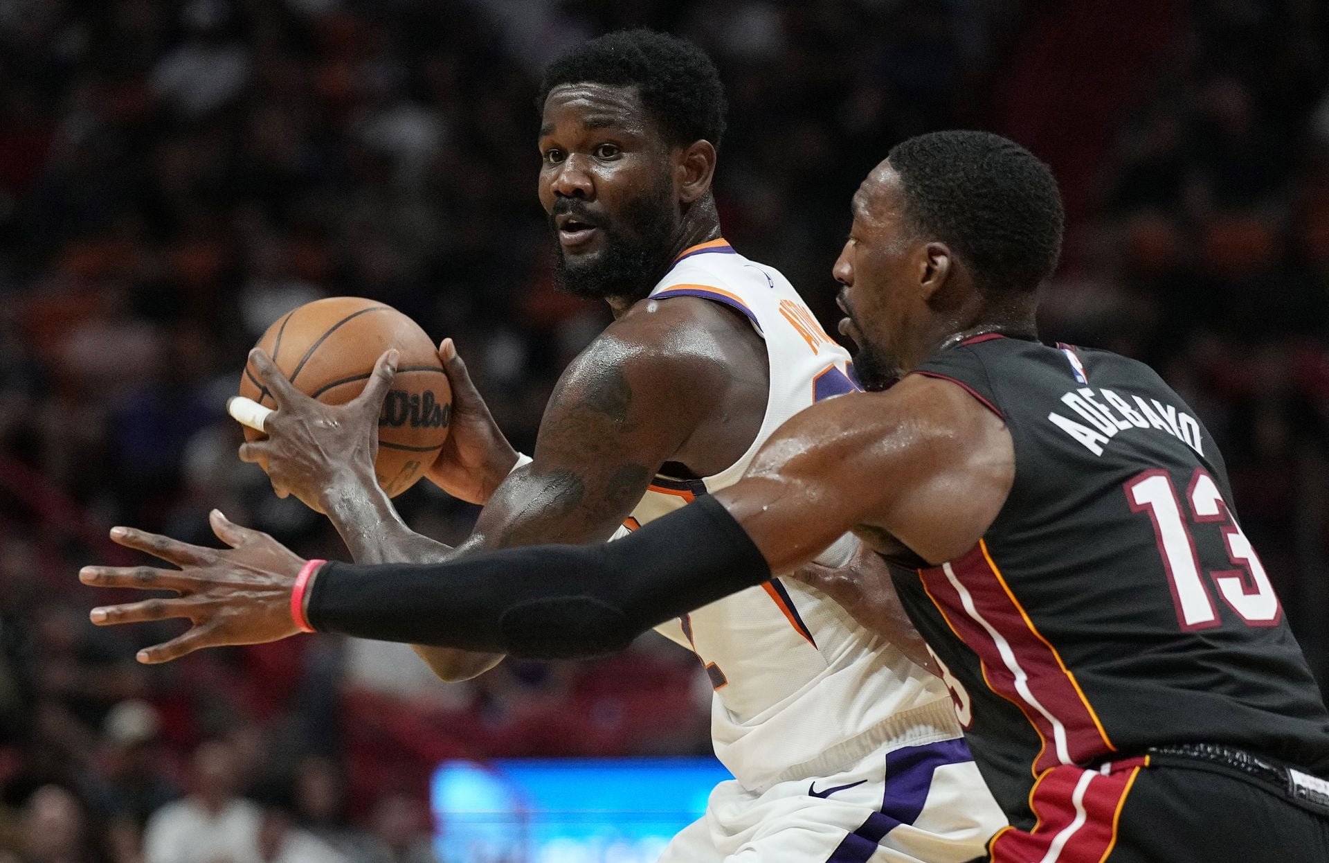 Phoenix Suns center Deandre Ayton (22) looks to pass as Miami Heat center Bam Adebayo (13) defends in the first half at FTX Arena in Miami, Florida on Nov 14, 2022.