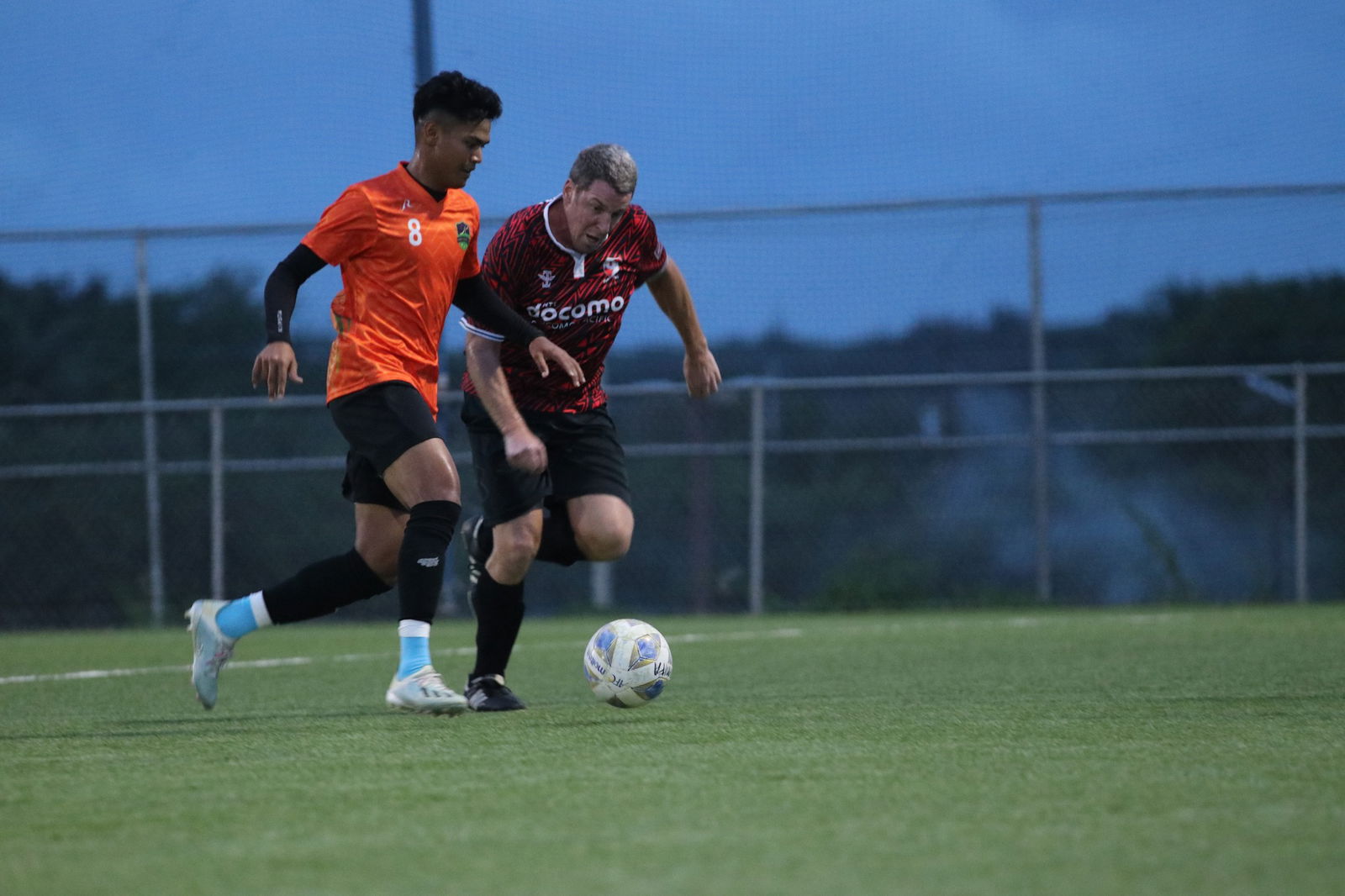 PFC's Travis Spaeth battles for the possession during a Division A game of the Marianas Soccer League at the NMI Soccer Training Center.