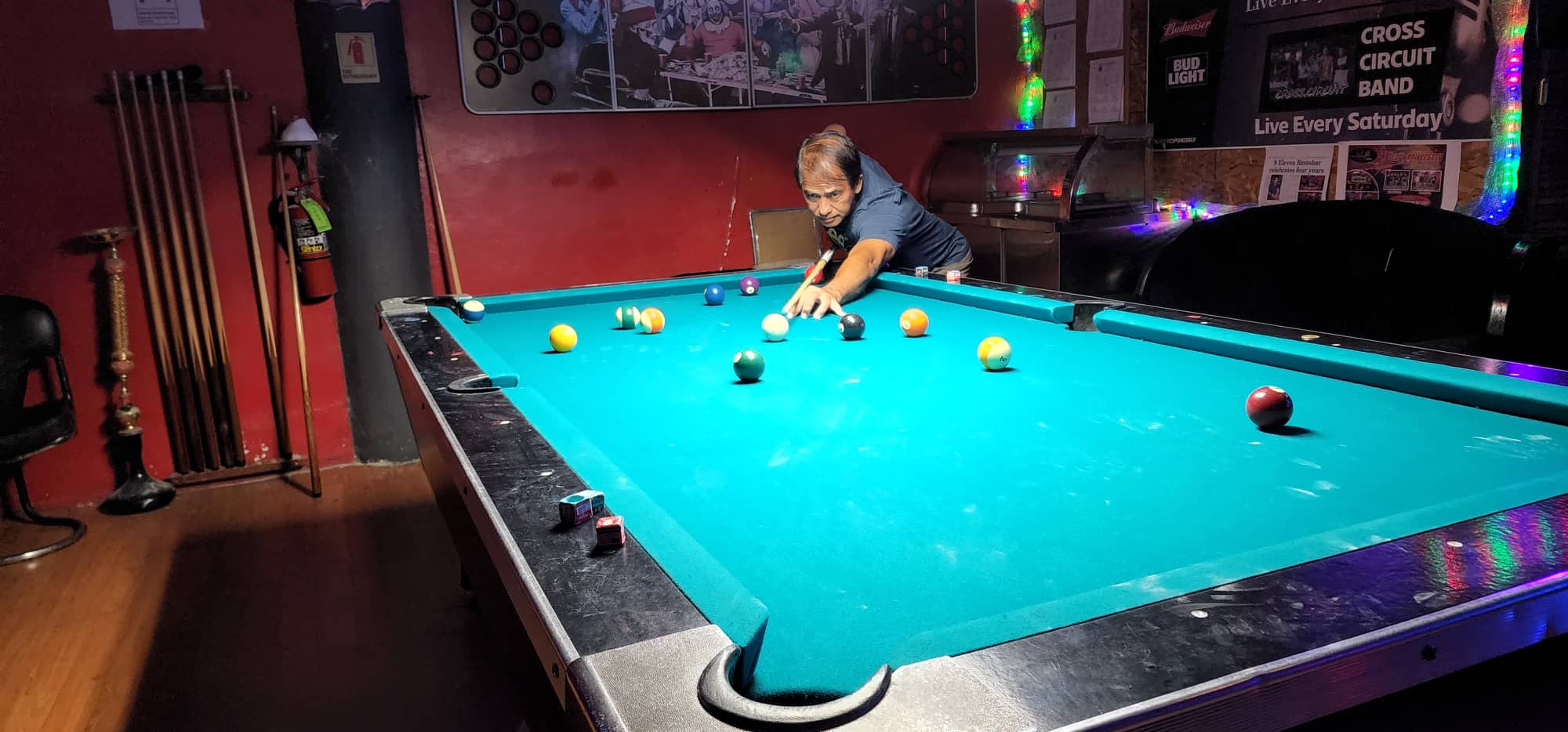 SCS Just Chillin's Rowel Mariano lines up for a shot during a Thursday Division game of the SBA Budweiser Open 8-Ball League at the 9 Eleven Restobar.