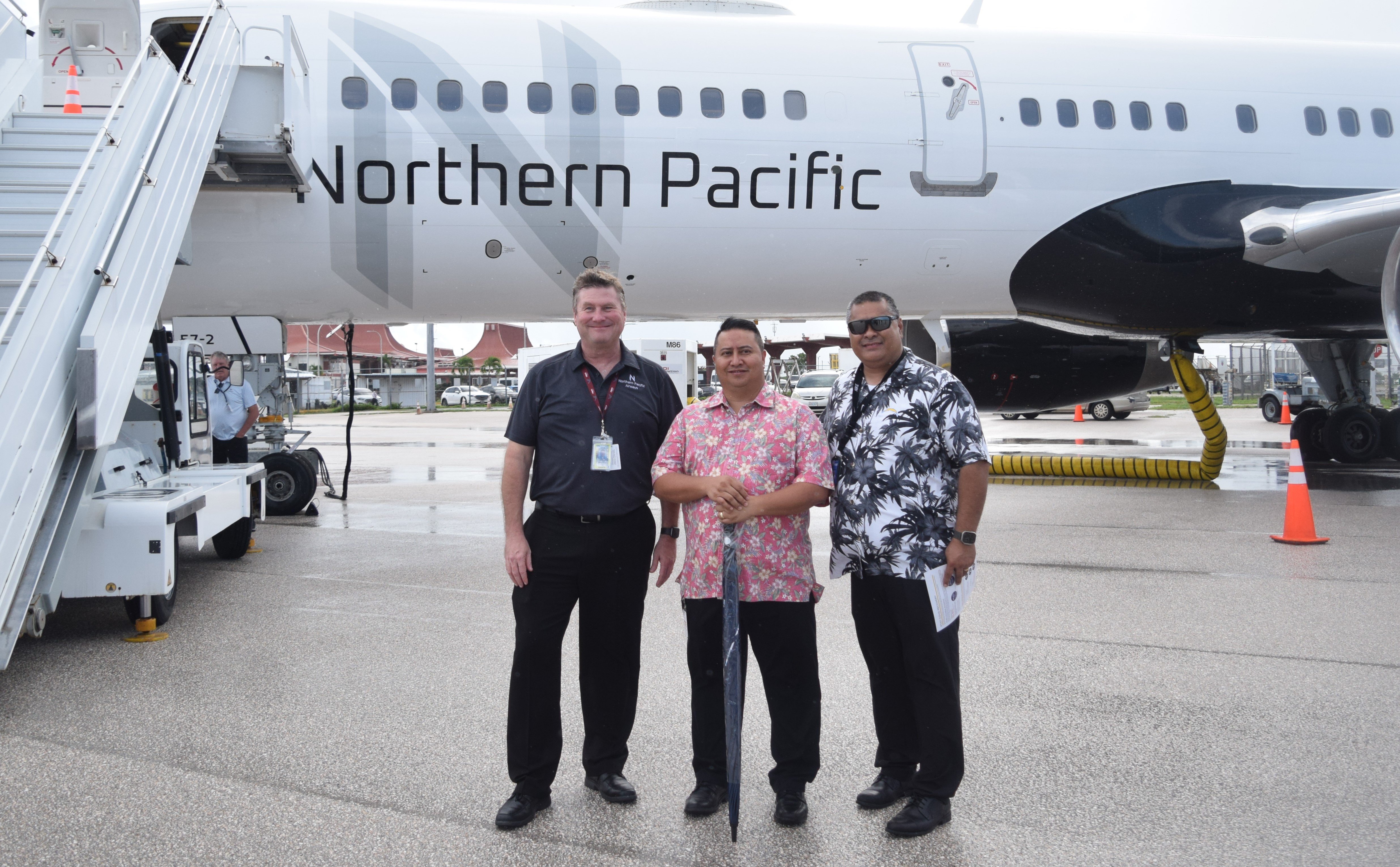 Gov. Ralph DLG Torres, center, with Finance Secretary David DLG Atalig, right, and Rob McKinney, chief executive officer of Northern Pacific Airways pose next to a Boeing 757-200 on Oct. 20, 2022 at the Francisco C. Ada/Saipan International Airport.