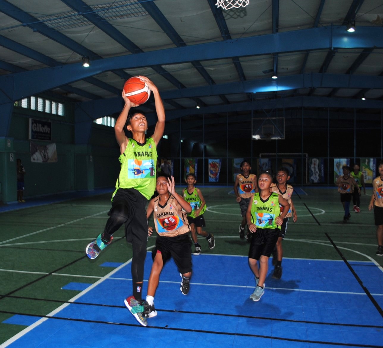 Tanapag's Dale Garcia extends for the finish during a U13 boys division game of the 2022 Marianas Village Pride Basketball League Saturday at the TSL Sports Complex.