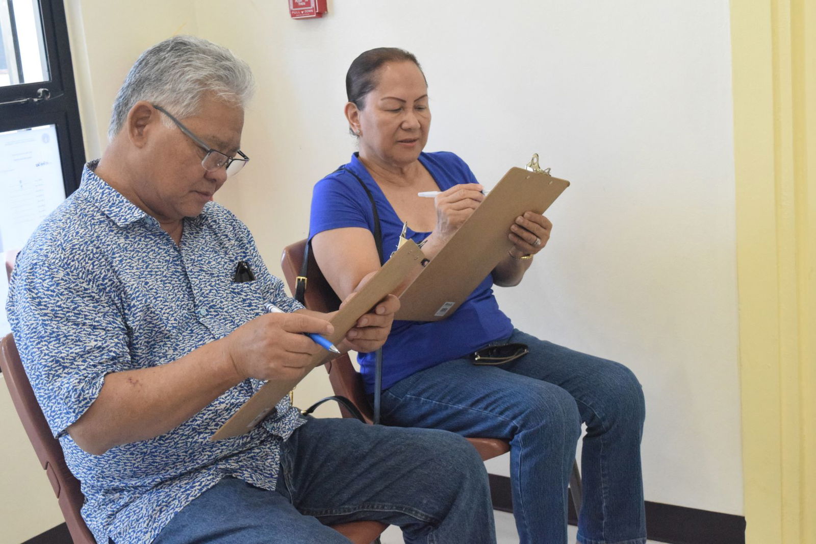 Lt. Gov. Arnold I. Palacios and Second Lady Wella Palacios fill out an early-voting form at the multi-purpose center in Susupe on Friday.