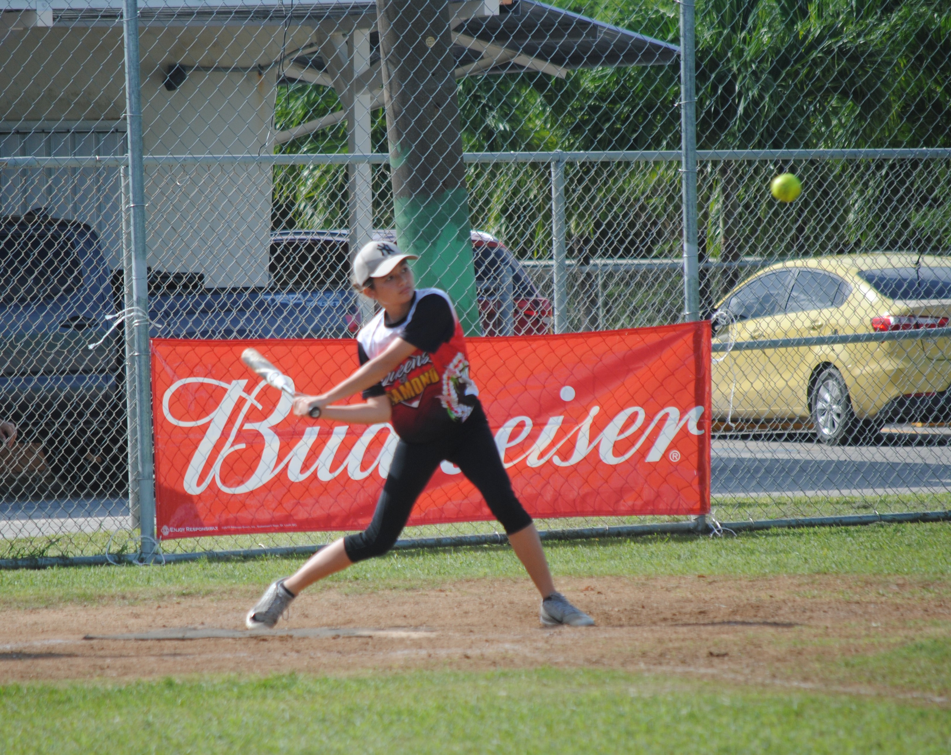 Queens of Diamonds’ Kiana Camacho is about to connect the single during a  women's division game of the 2022 Budweiser Belau Amateur Softball League at the Dandan baseball field.
