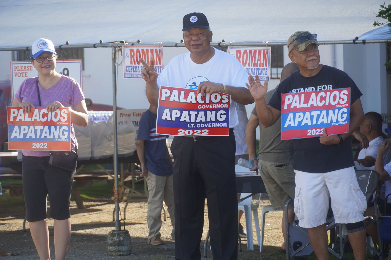 Saipan Mayor David M. Apatang, center, poses for a photo at a roadside waving activity in Precinct 1 early Tuesday morning.