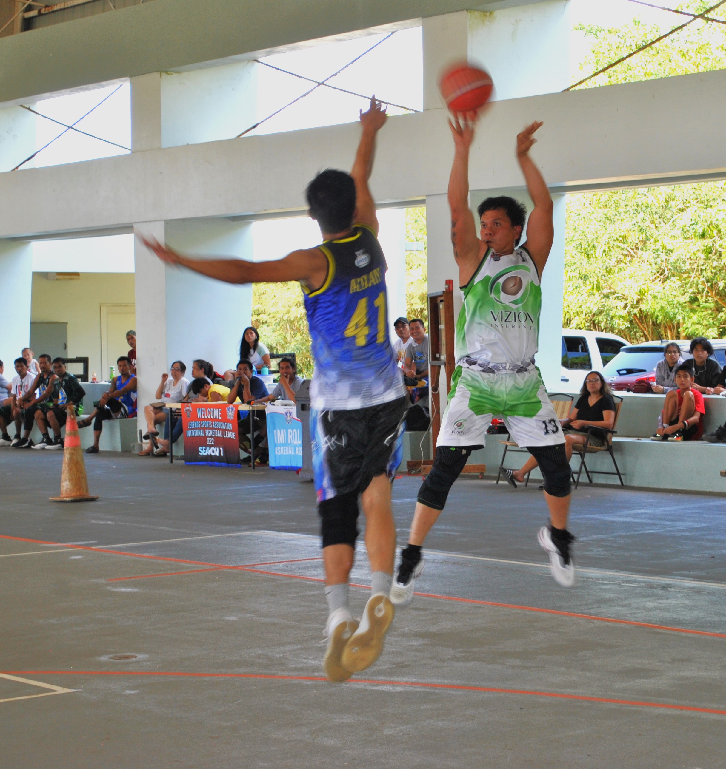 Vizion's Ronald Rueda takes the three-point shot over a defender during an open division game of the 2022 Legends Sports Association Invitational Basketball League Sunday at the Koblerville gym.
