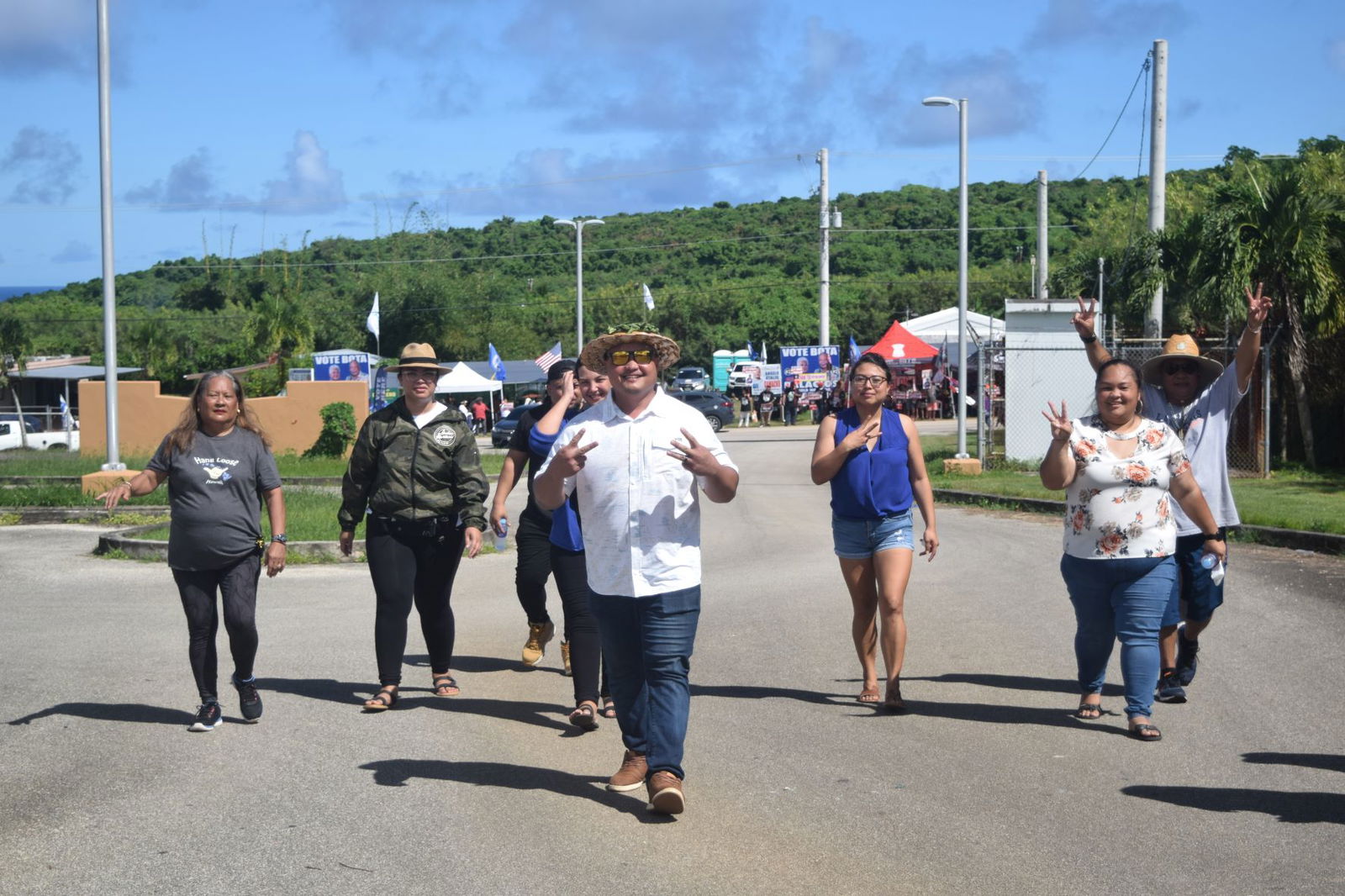 Independent Precinct 5 House candidate Angelo Atalig Camacho is accompanied by family and supporters  at the Kagman polling center on Tuesday.