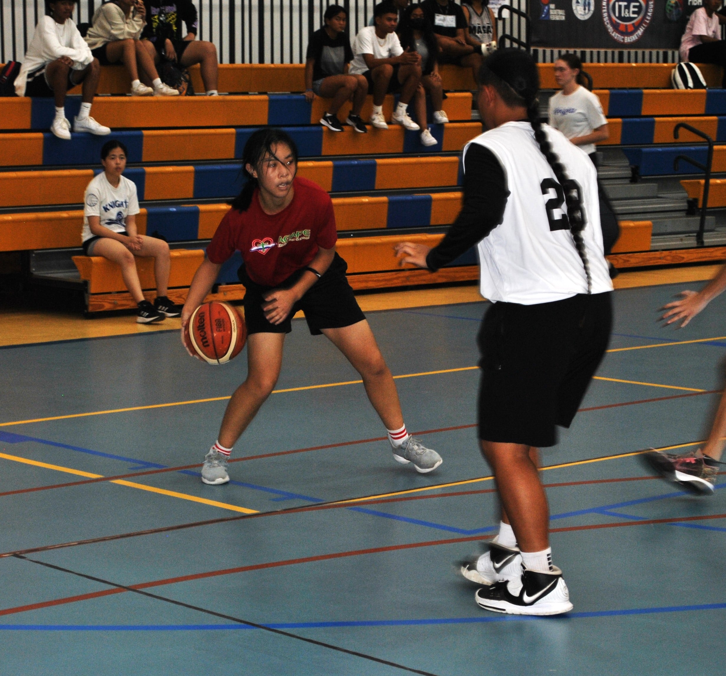 Agape’s Eunice Xu protects the ball as defenders close in during a girls high school division game of the IT&E Interscholastic Basketball League on Wednesday at the MHS gym.