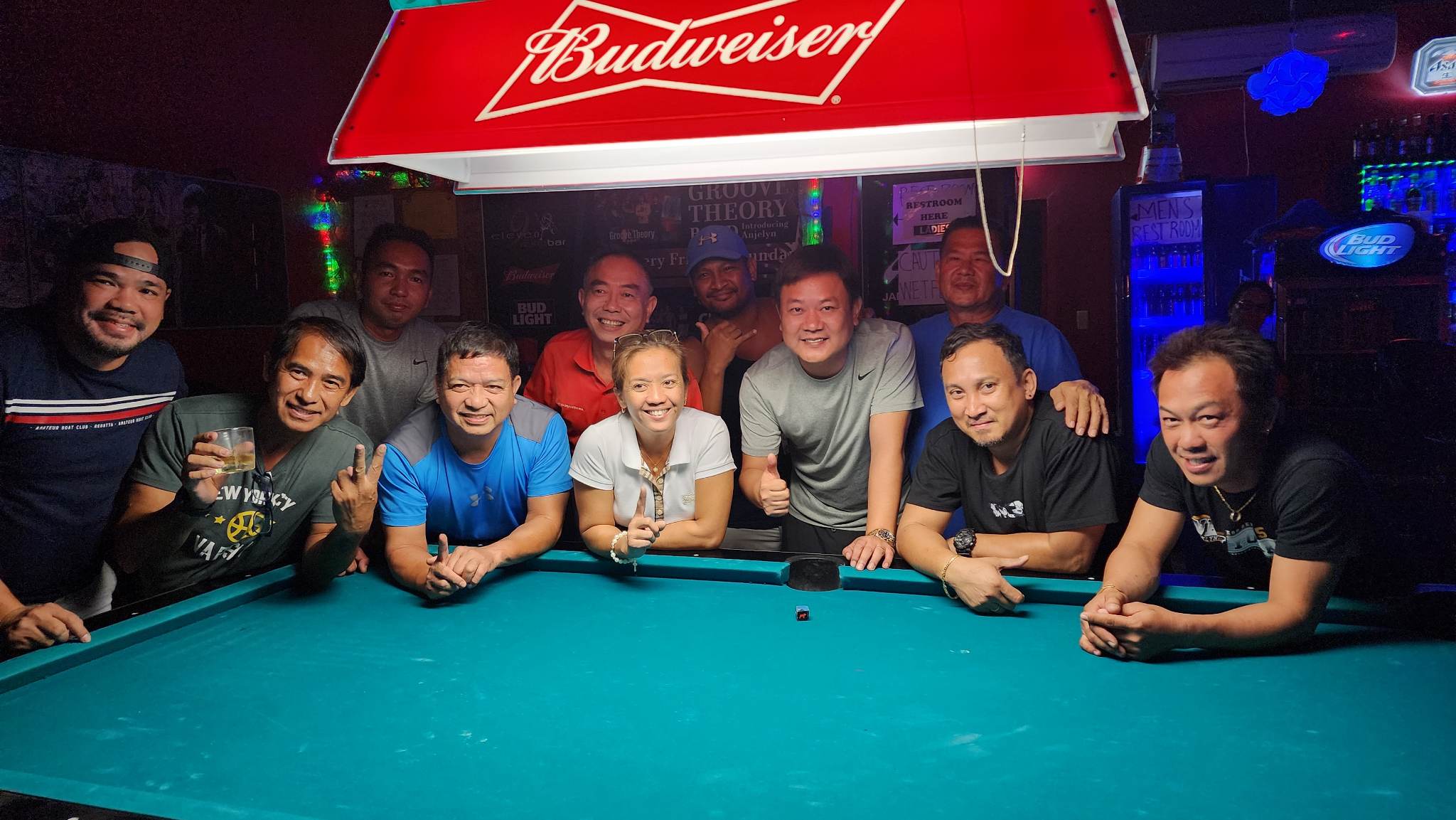 The Ideal Signs JC Rustlers pose for a photo after winning the SBA Open 8-Ball League-Tuesday Division Budweiser Cup match at 9 Eleven Restobar.