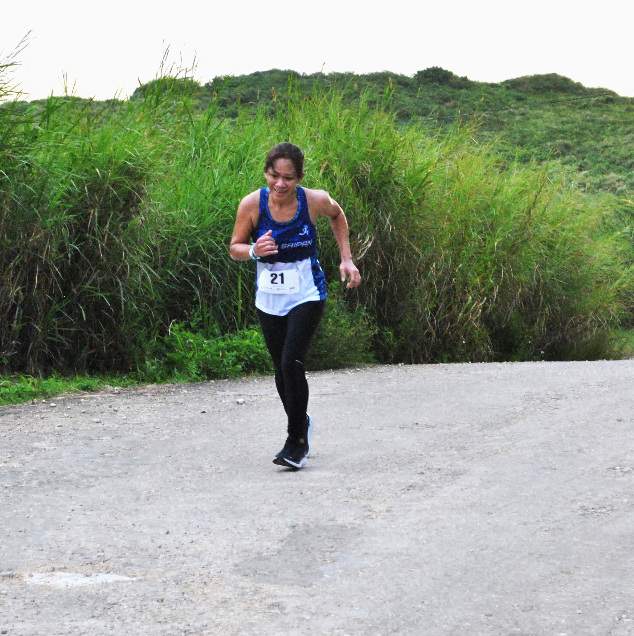 Rosemarie Chisato takes a breather as she reaches the finish line to top the 40-49 age group of Turkey Trot 2022 on Thursday at Mt. Tapochao.