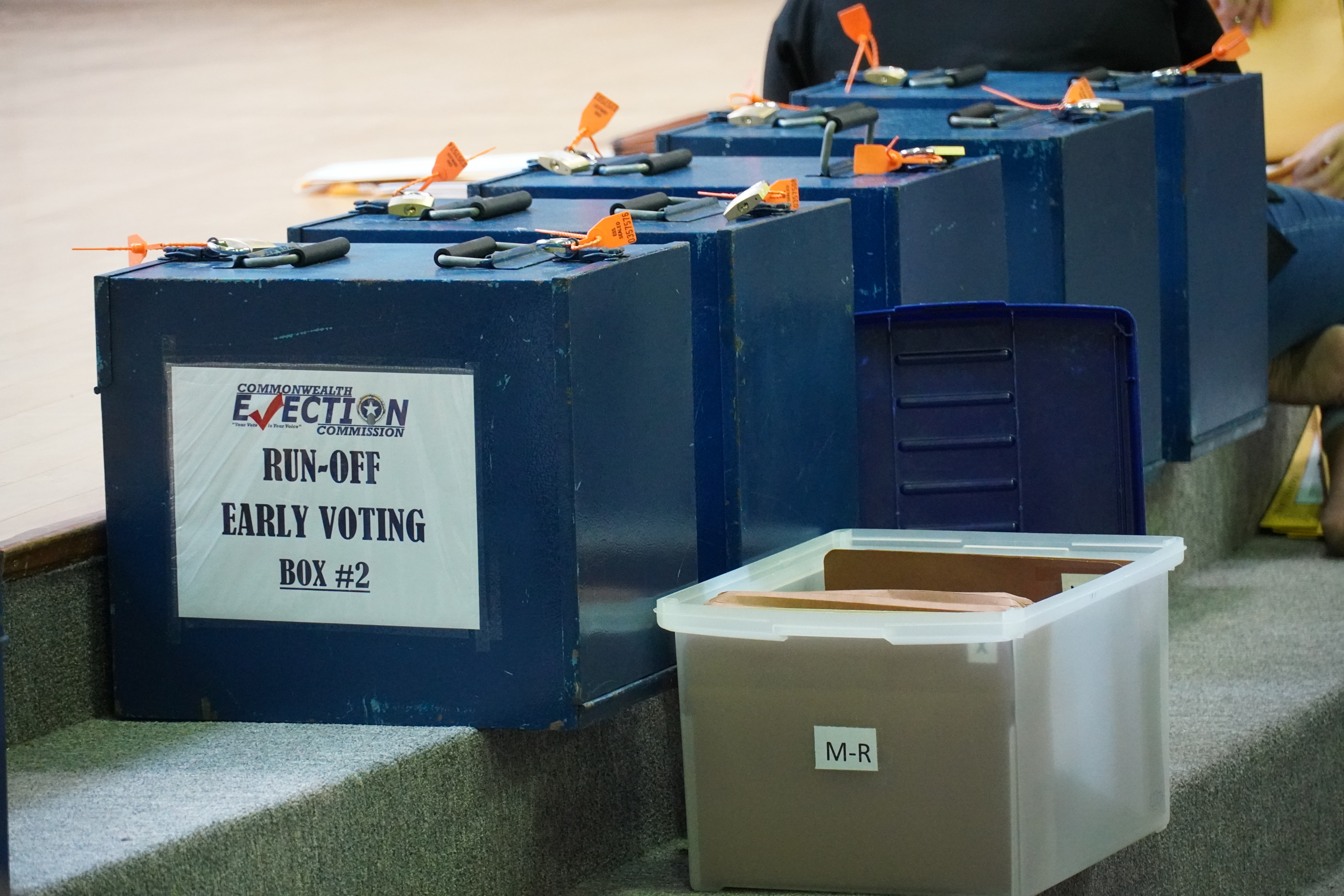 Runoff early voting ballot boxes, still locked, await processing