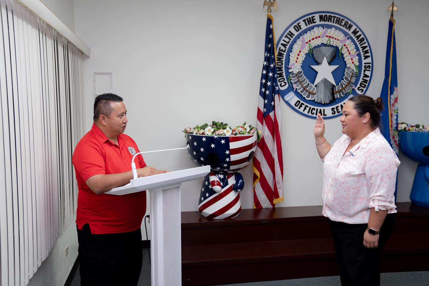 Geralyn C. Dela Cruz, right, is sworn in by Gov. Ralph DLG Torres.