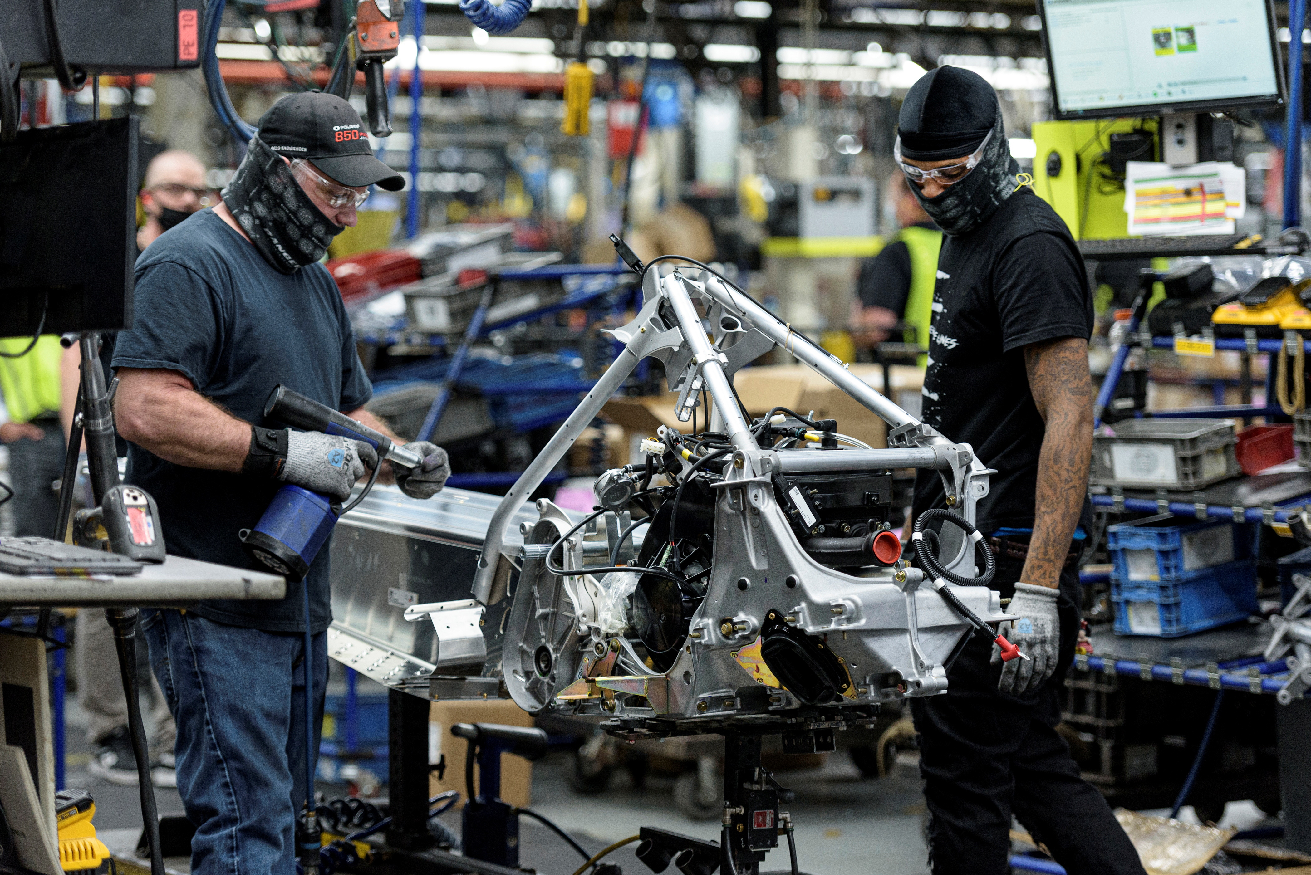 People work on a Polaris snowmobile assembly line at their manufacturing and assembly plant in Roseau, Minnesota, June 7, 2021.