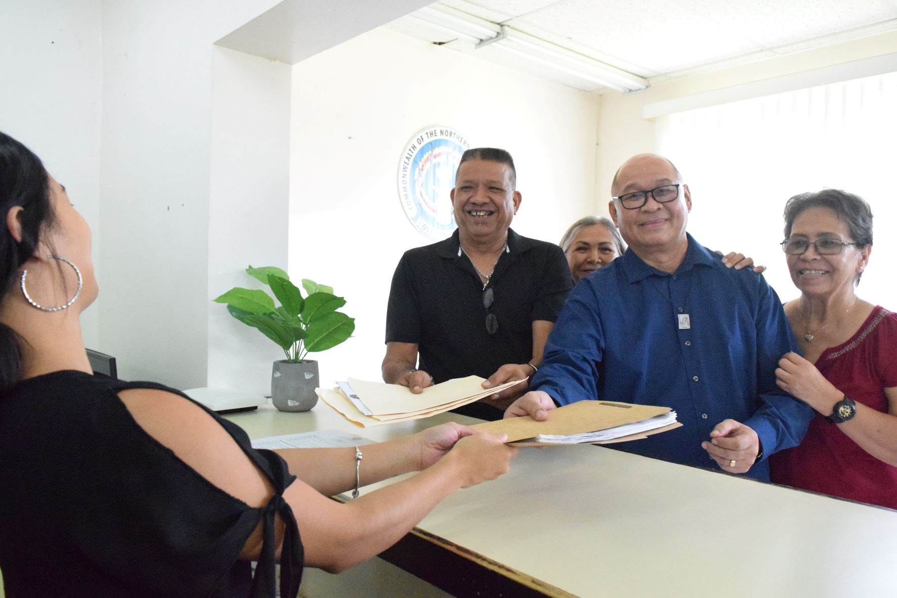 Rota independent candidate, Harry James A. Masga, 2nd right, files his candidacy in July 2022 with his family and other supporters at the Commonwealth Election Commission.
