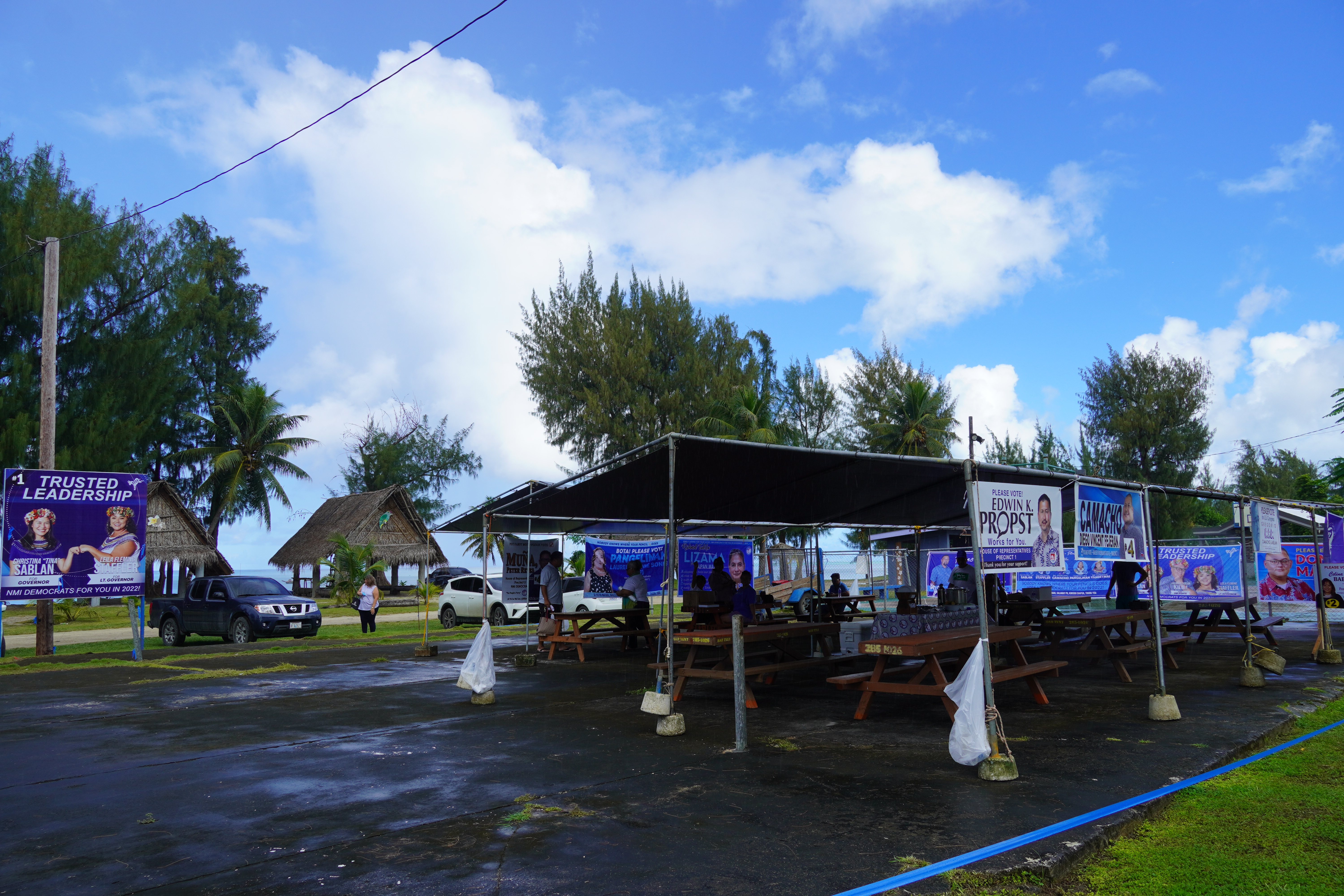 Supporters, candidates and party leaders gather early Tuesday morning under the NMI Democratic Party canopies across from the multi-purpose center.
