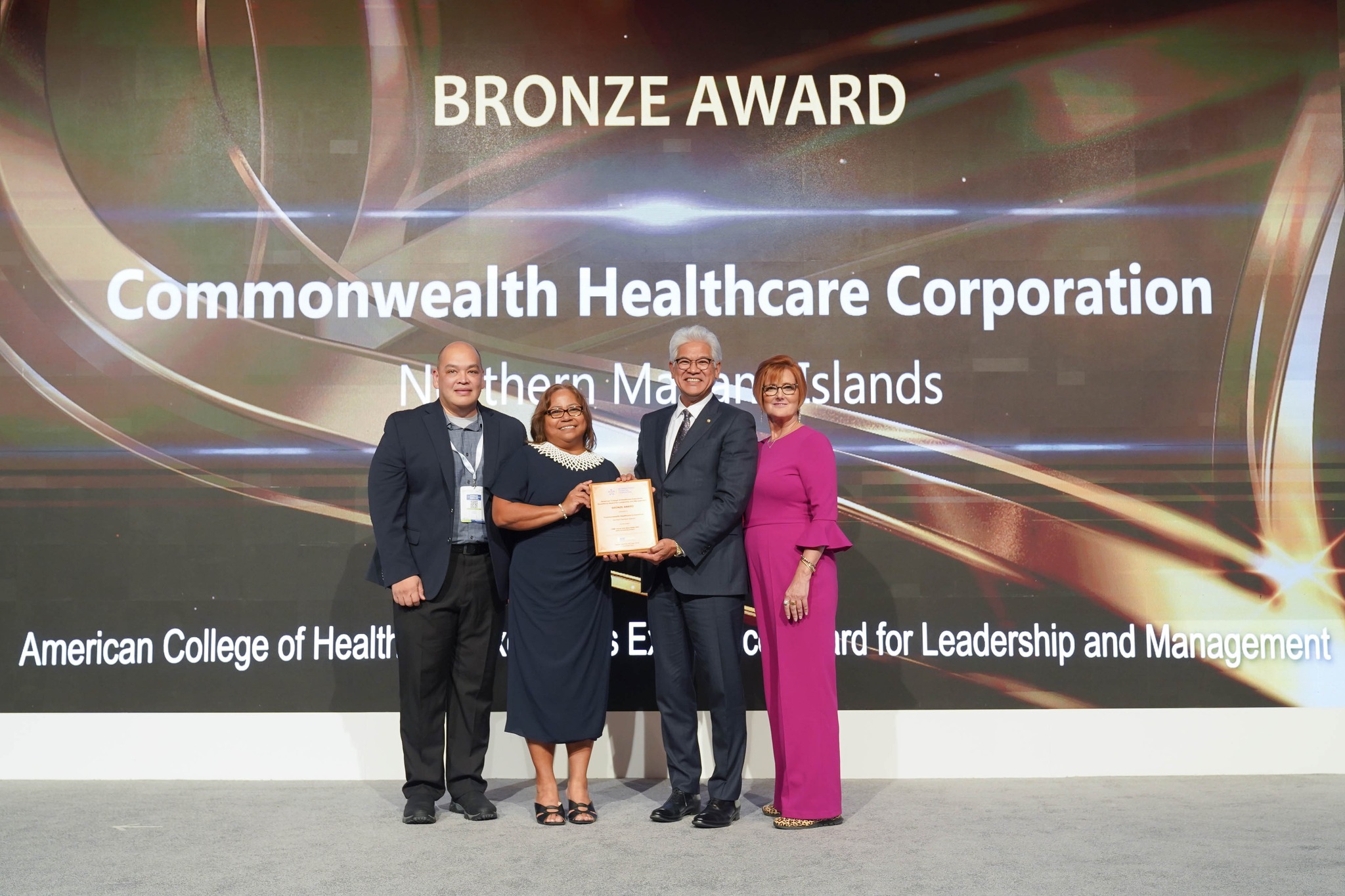Commonwealth Healthcare Corporation Chief Executive Officer Esther L. Muna and Dr. John Tudela accept the  bronze American College of Healthcare Executives Excellence Award for Leadership and Management in Dubai, where this year's International Hospital Federation Awards ceremony was held.