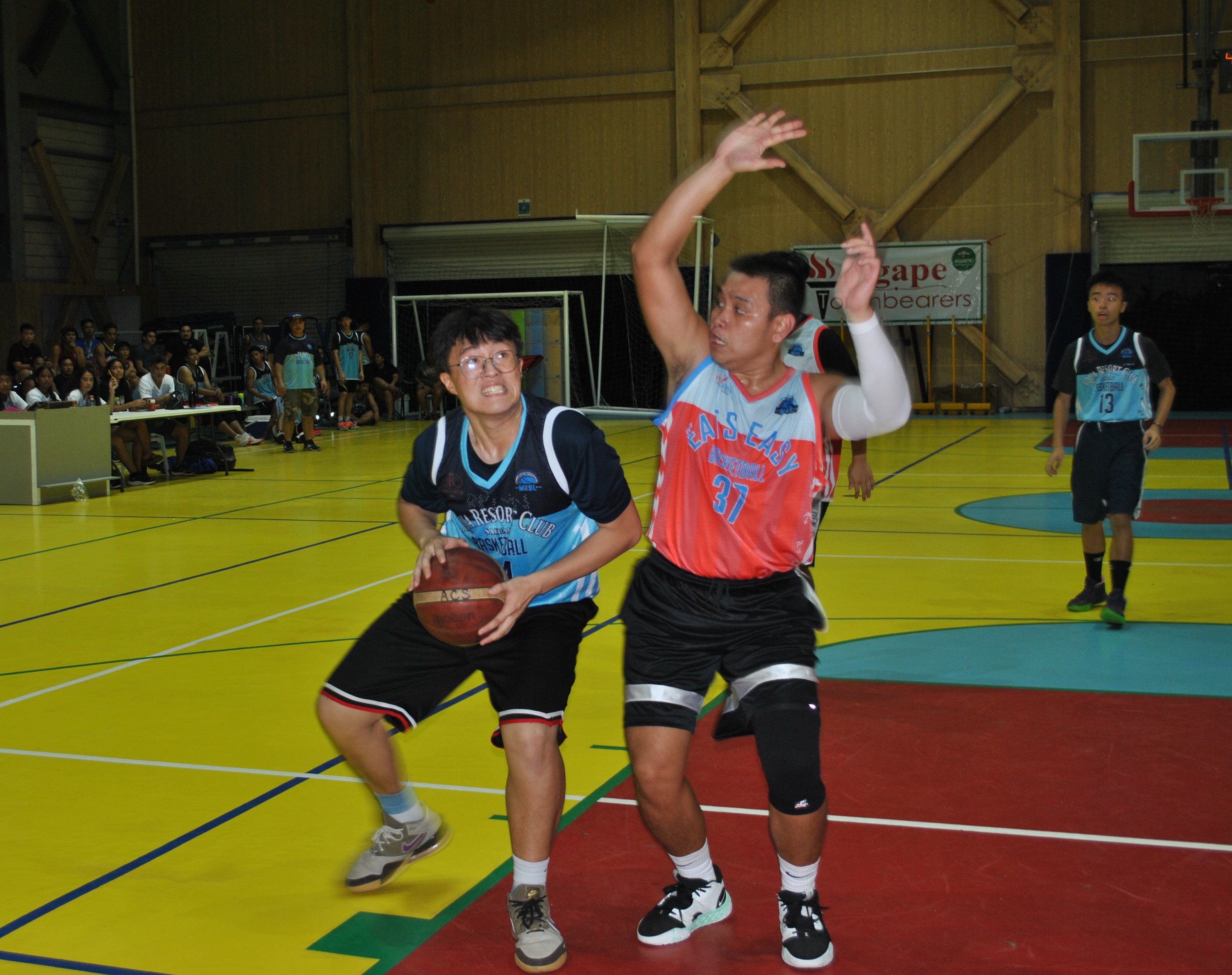 Eats Easy's Arfin Chua extends to contest the shot of Aqua's Michael Ma during an MIBL Fantasy Draft game Friday at the ACS gym.  