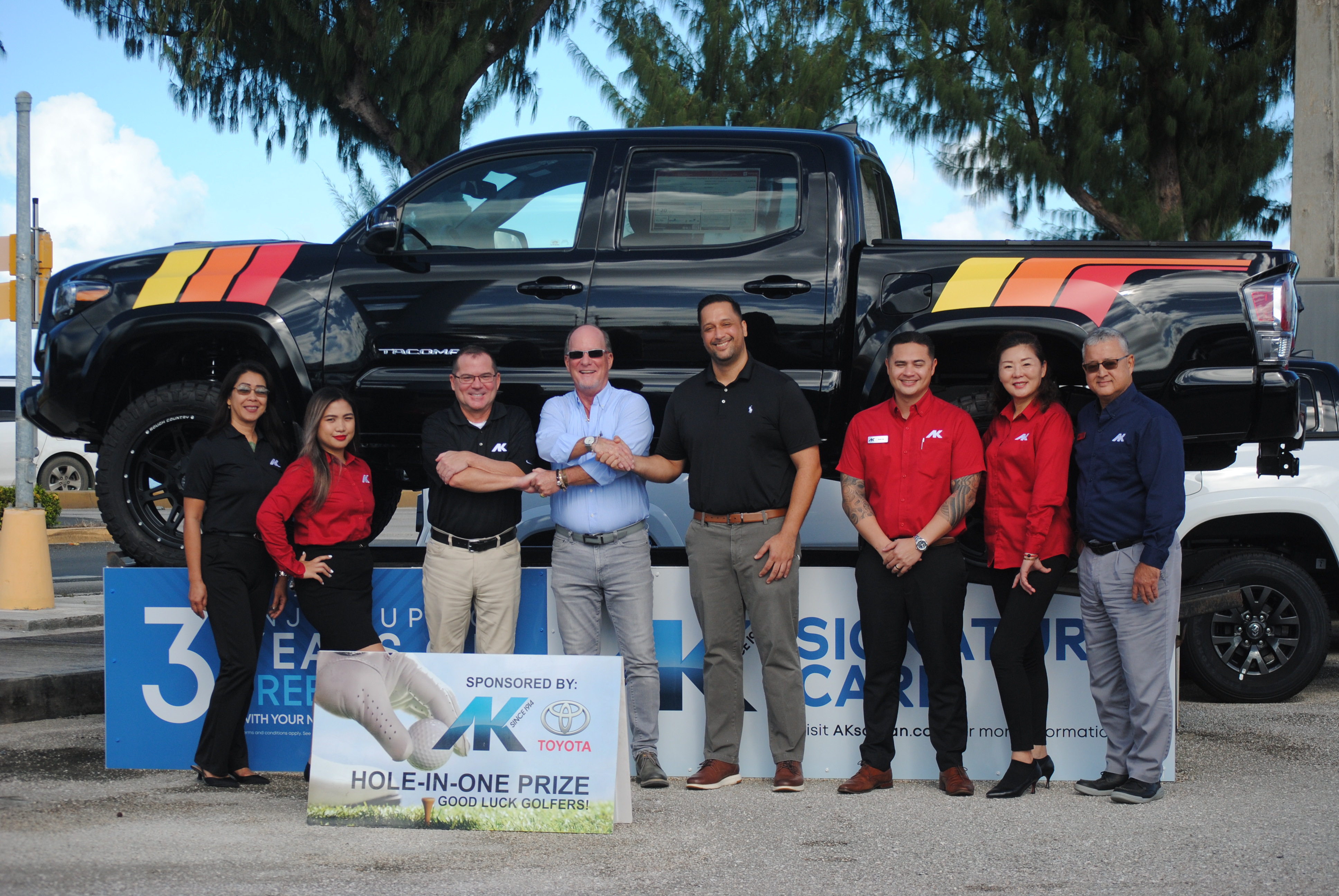 AK Finance & Insurance Manager Malou Berueco, Sales Associate Kim Calage, General Manager and Vice President of AK Guam & Saipan Joel Lesh, IT&E Enterprise Sales Manager Hans Mickelson, AK Sales Manager Kevin Barnes, AK Sales Associate Kevin Ada, AK Sales Associate Didi Woodruff, and AK Business Manager Joaquin Blanco pose with the 2022 Tacoma TRD Sport that will be the hole-in-one prize for hole #4 in the VISA Marianas Golf Classic which will be held this Saturday at Laolao Bay Golf & Resort.