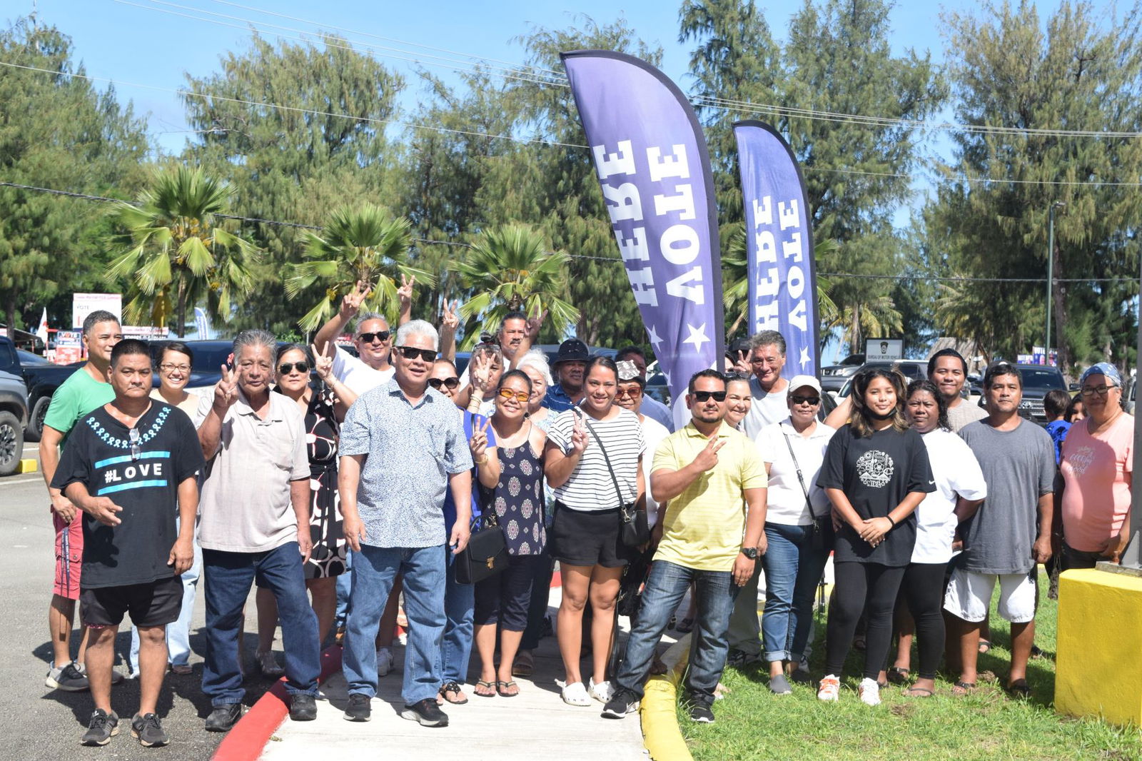 Lt. Gov. Arnold I. Palacios, third left, front row, with his family members and other supporters pose for a photo before heading to the multi-purpose center in Susupe on Friday.