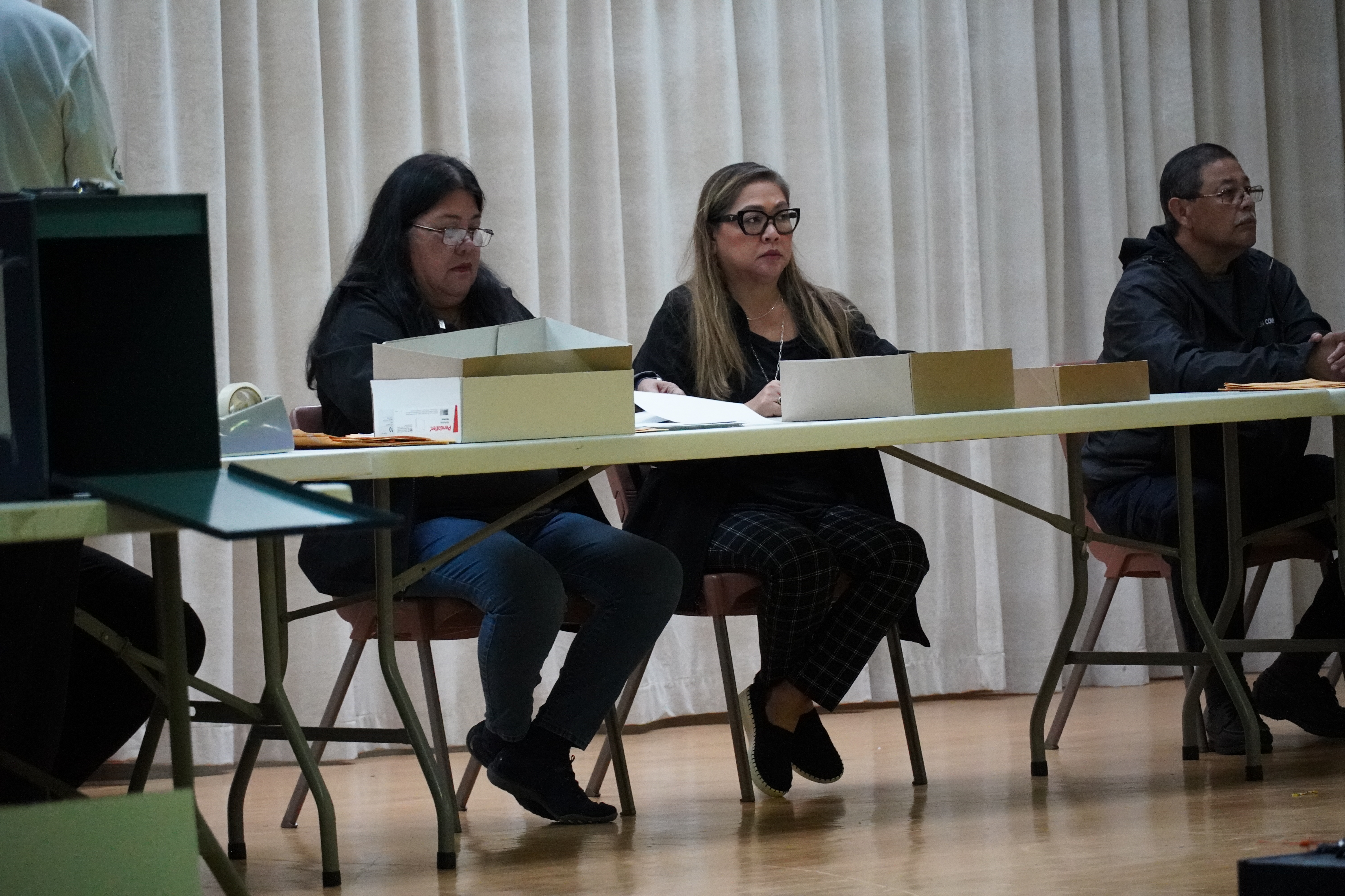 Election Commissioners Esther Yatar, Dorisann Aldan-Atalig, and Jesus Cepeda process ballots from runoff early voting box one, the first to be processed.