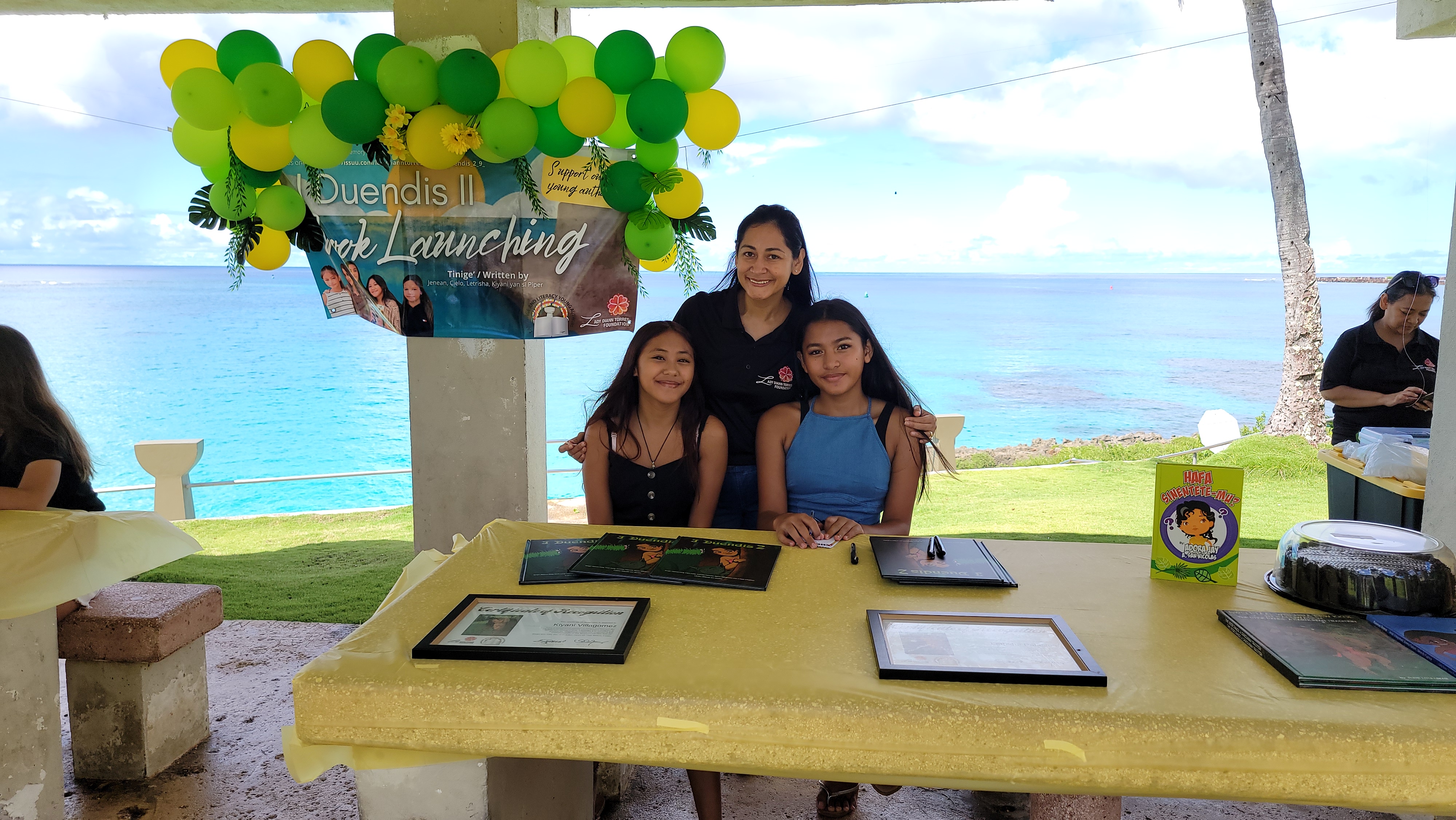 First lady Diann Torres with young authors Letrisha Palacios and Kiyani Villagomez.