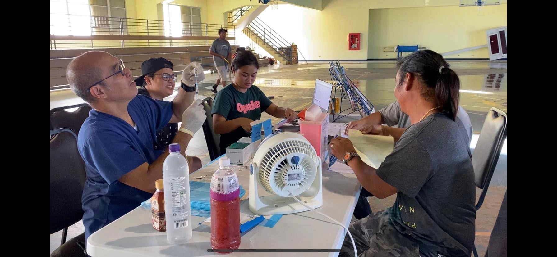 Nurse Sidney Biton is about to give a flu shot.