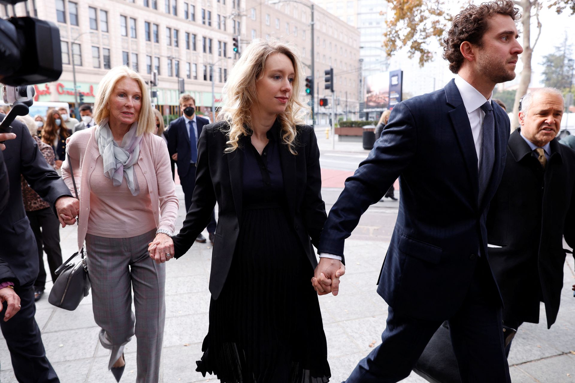 Theranos founder Elizabeth Holmes arrives with her family and partner Billy Evans to be sentenced on her convictions for defrauding investors in the blood testing startup at the federal courthouse in San Jose, California, Nov. 18, 2022.