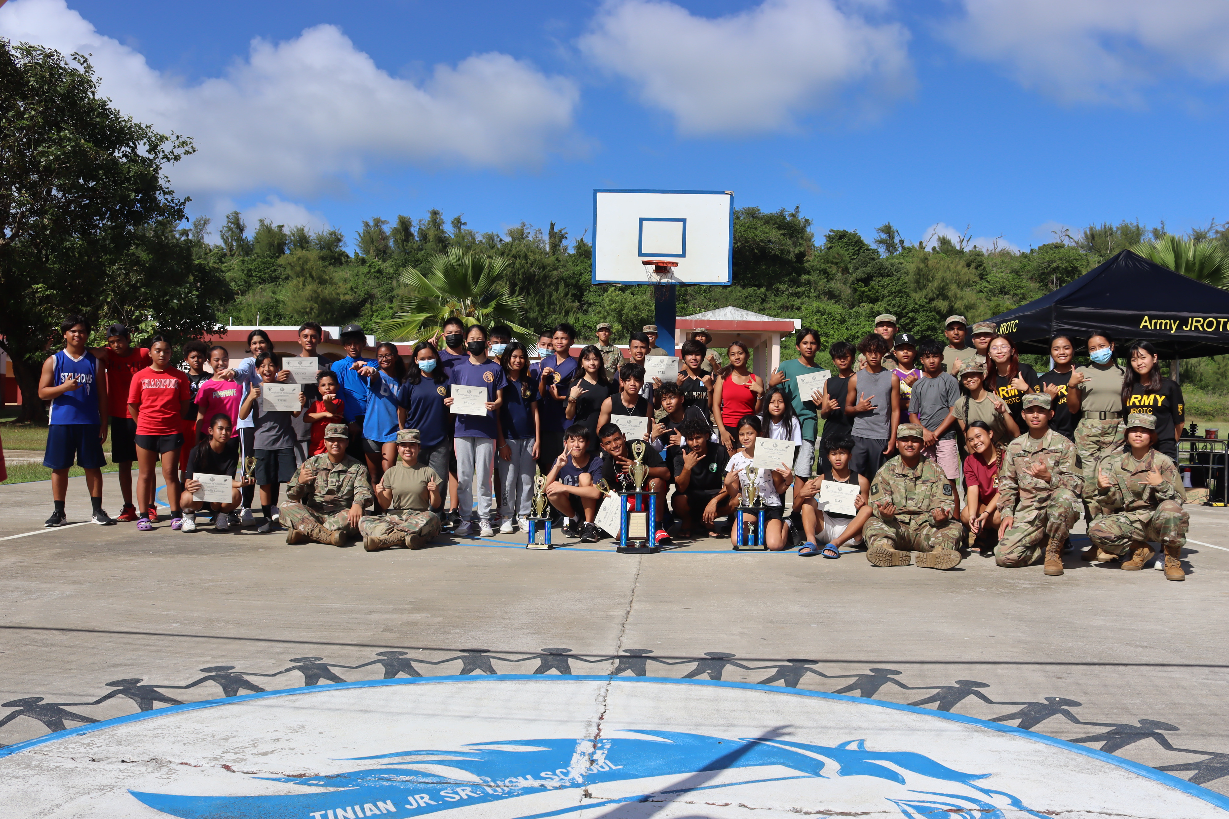 Students along with their instructors gather for a group photo at the First Annual Leadership Corps Cadet Challenge at the Tinian Jr. Sr. High School campus.