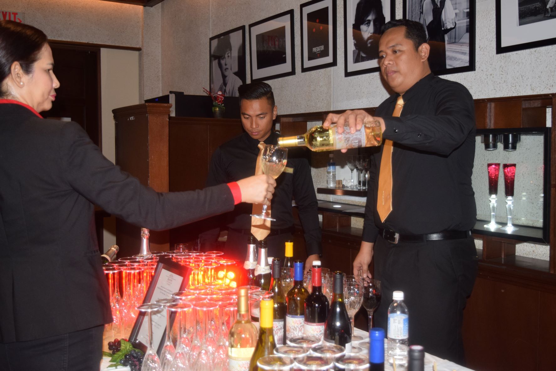 A bartender pours Aniti Sauvignon Blanc into a glass.
