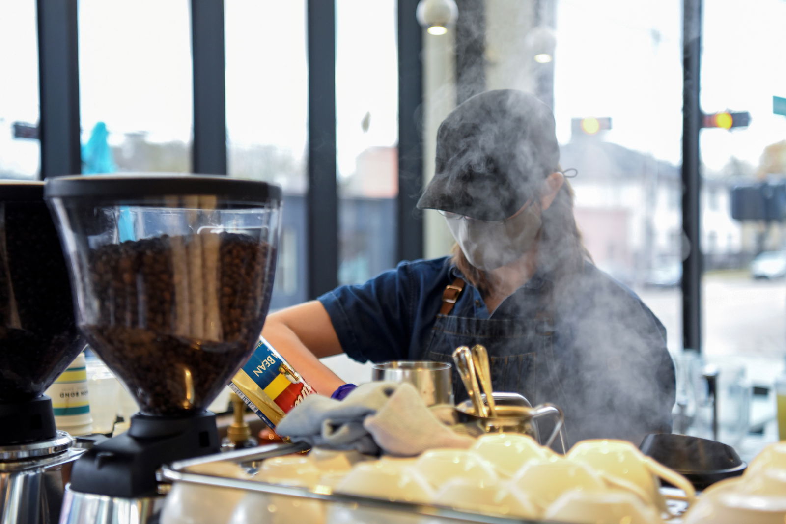 A barista makes coffee for a customer in Houston, Texas on March 10, 2021.