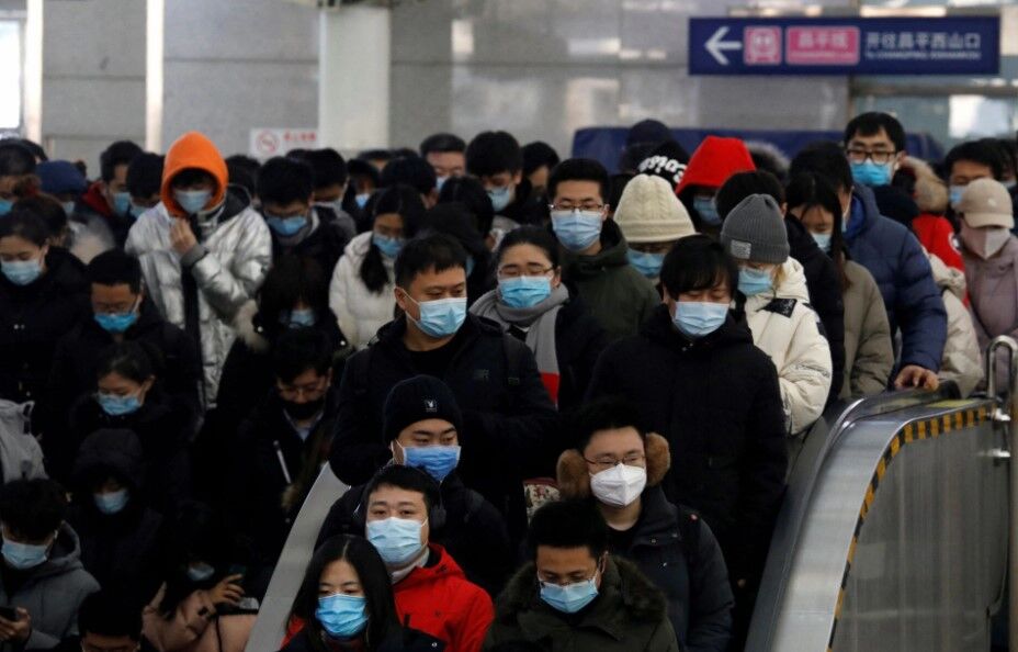 People wearing face masks commute in a subway station during morning rush hour, following the coronavirus disease outbreak, in Beijing, China on Jan. 20, 2021.