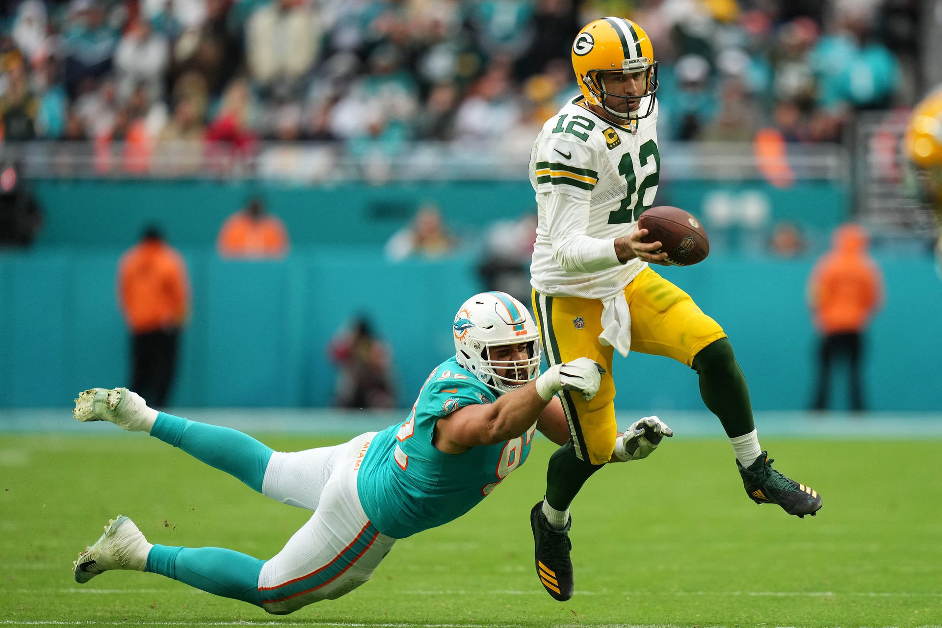 Miami Dolphins defensive tackle Zach Sieler (92) reaches for Green Bay Packers quarterback Aaron Rodgers (12) during the second half at Hard Rock Stadium in Miami Gardens, Florida, Dec. 25, 2022.