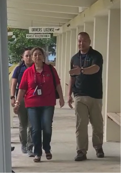 Department of Public Safety Acting Commissioner Juan Leon Guerrero, center, is seen with Federal Bureau of Investigation agent Hae Jun Park and another FBI agent on Friday as the FBI executed a search warrant at the Bureau of Motor Vehicles and the DPS  Information Technology office.
