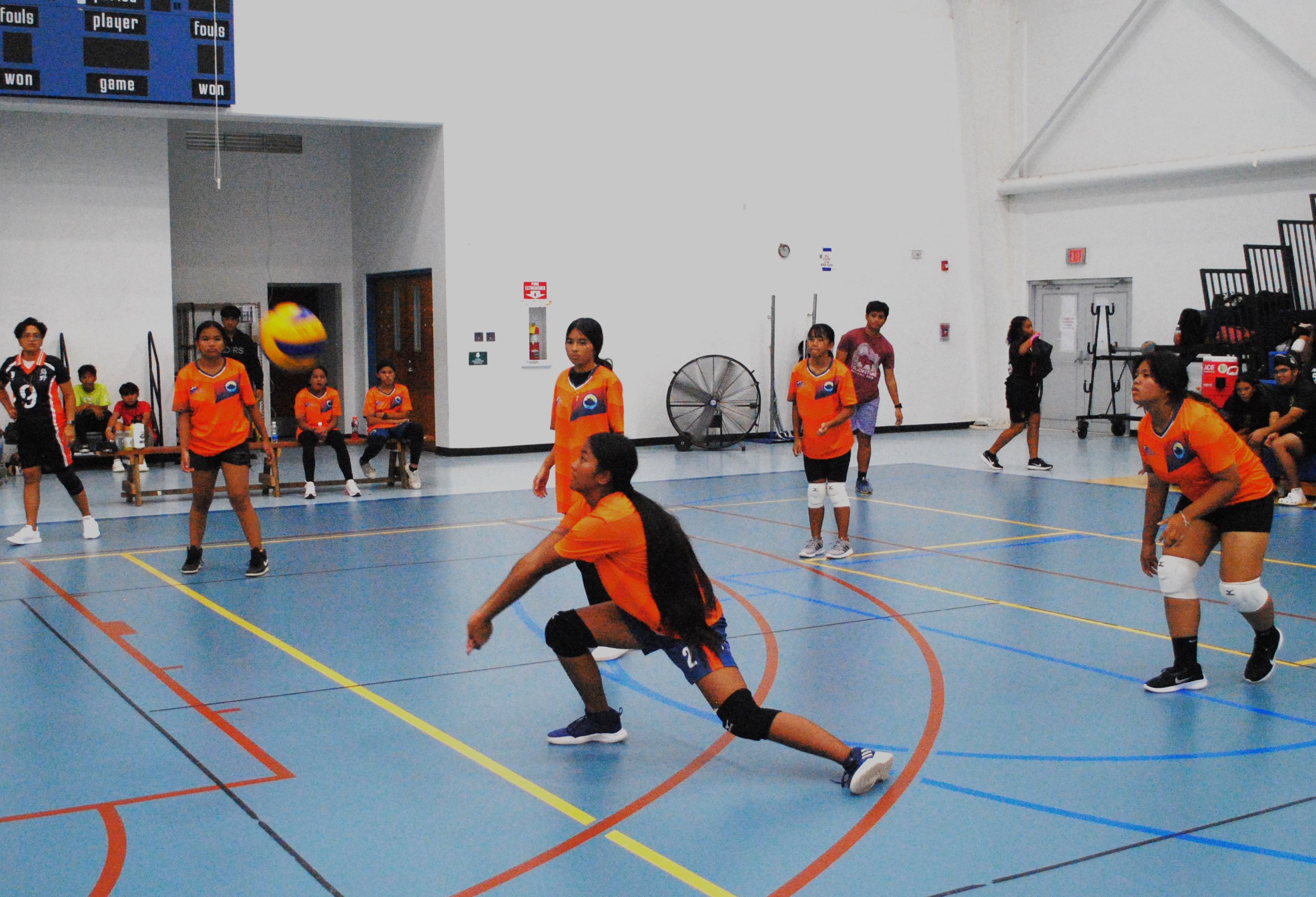 A Tanapag Middle School player bends down to save the possession during a girls middle school division game of the NMIVA-PSS Interscholastic Volleyball League at the MHS gym on Tuesday