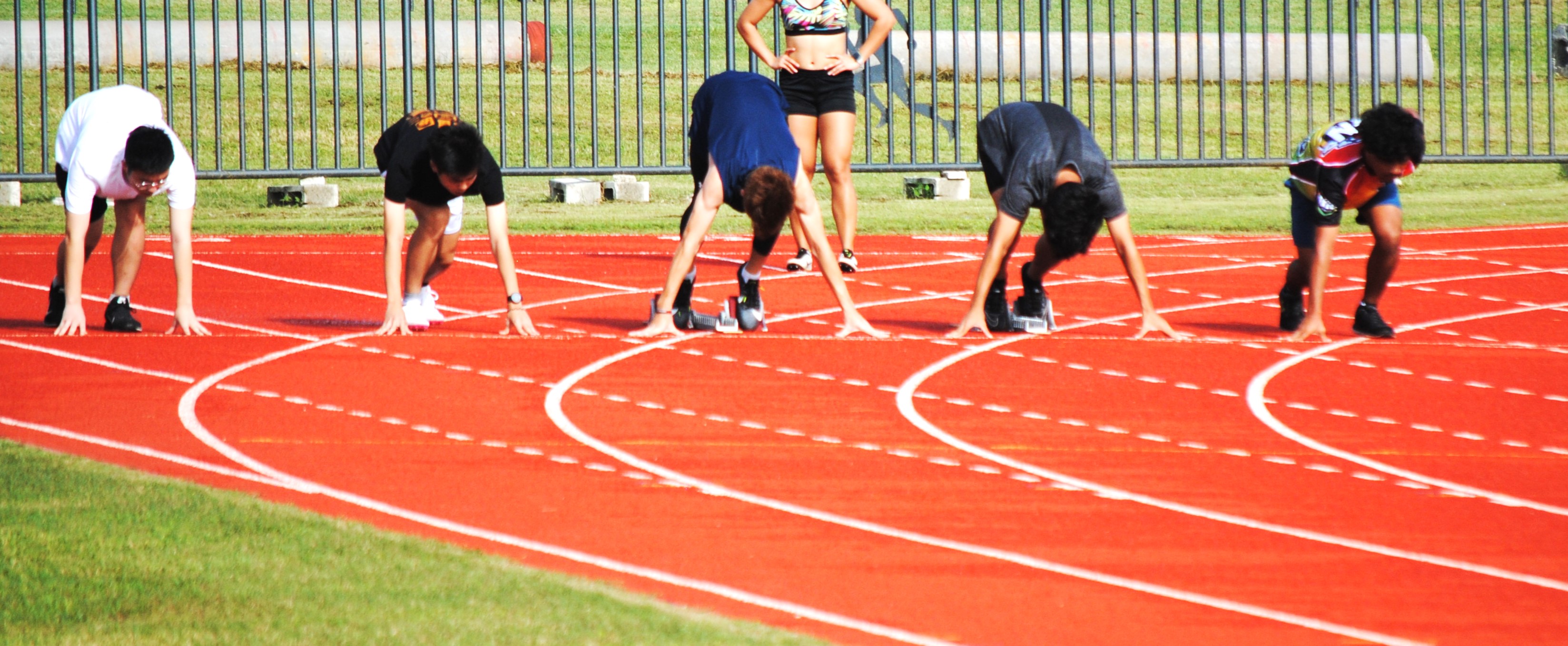 Participants prepare for the start of the 100m event.