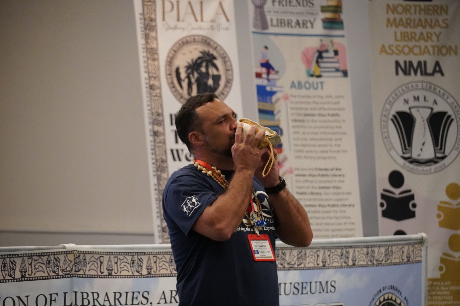 Northern Marianas Humanities Council Executive Director Leo G. Pangelinan blows a "kulu" or conch shell.