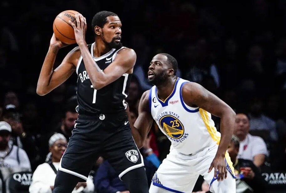 Golden State Warriors' Draymond Green (23) defends Brooklyn Nets' Kevin Durant (7) during the first half of an NBA basketball game Wednesday, Dec. 21, 2022 in New York.