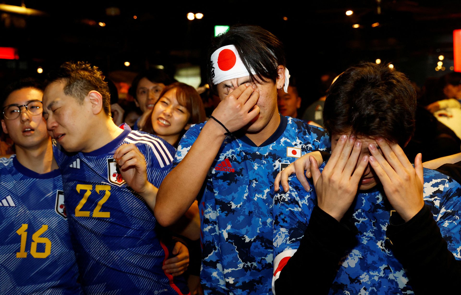 Japanese fans react as they watch the Japan-Croatia penalty shootout at the Bee bar in Tokyo, Japan on Dec. 6, 2022.