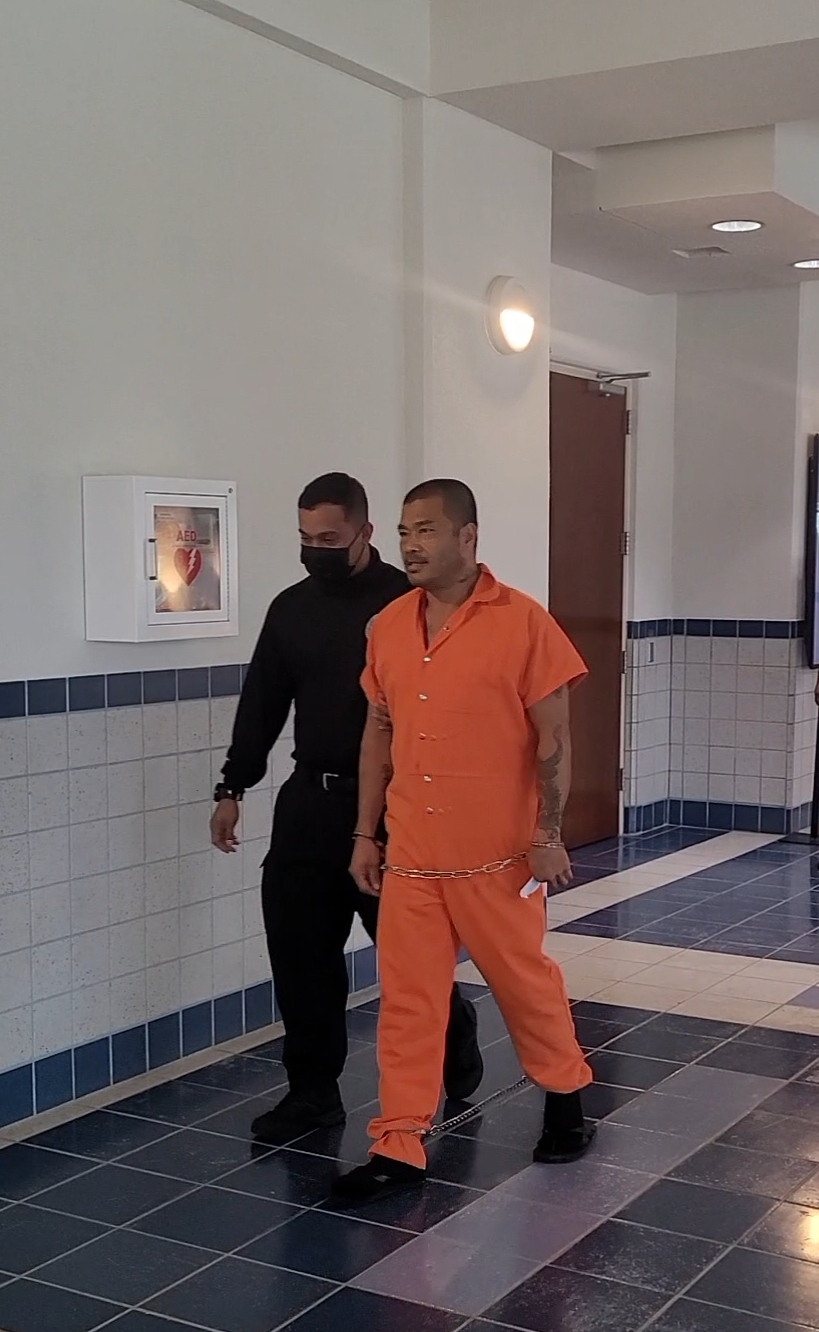 Morell Esteves is escorted by a Corrections officer at Guma Hustisia on Monday.
