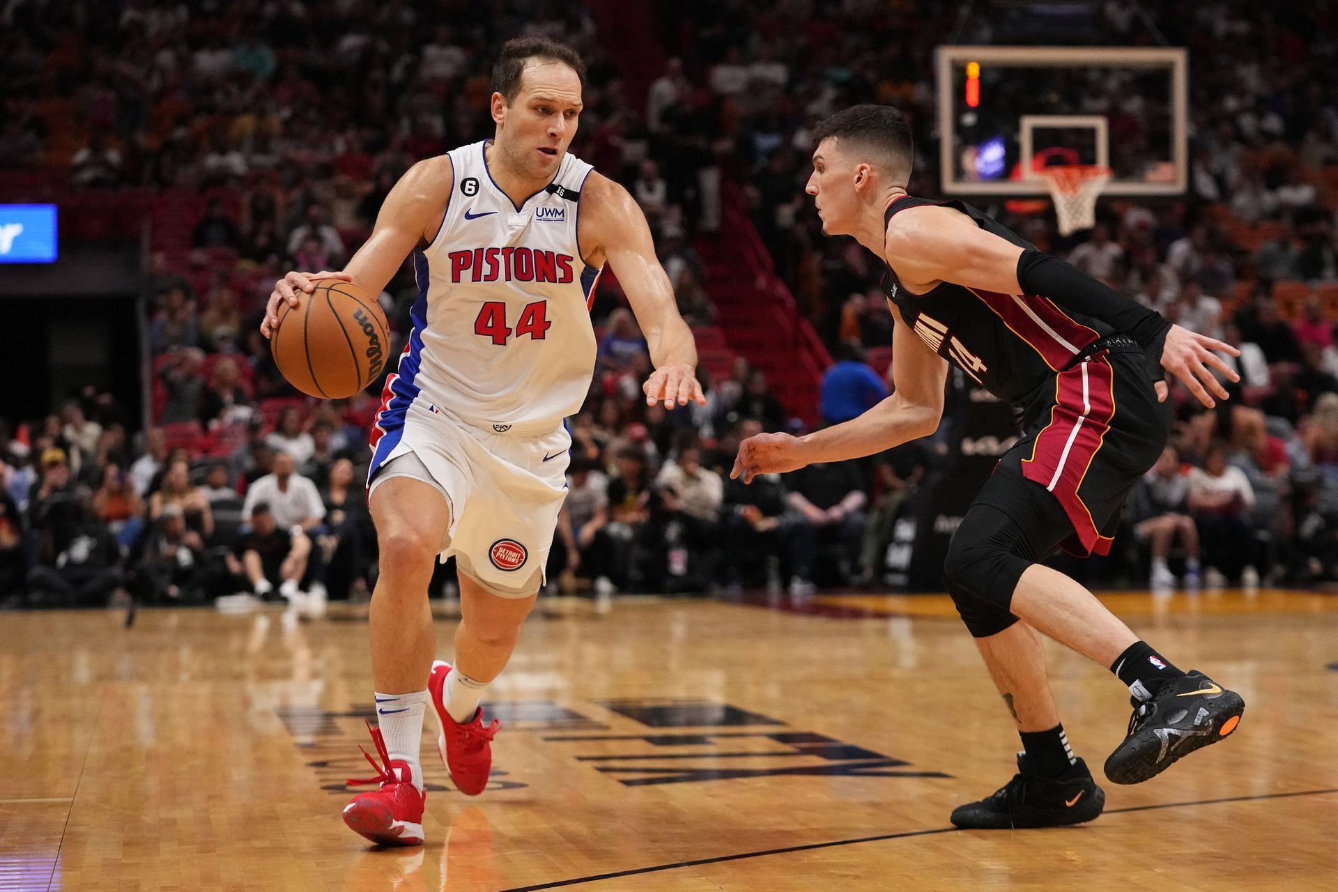 Detroit Pistons forward Bojan Bogdanovic (44) drives the ball around Miami Heat guard Tyler Herro (14) during the second half at FTX Arena in Miami, Florida, Dec. 6, 2022.