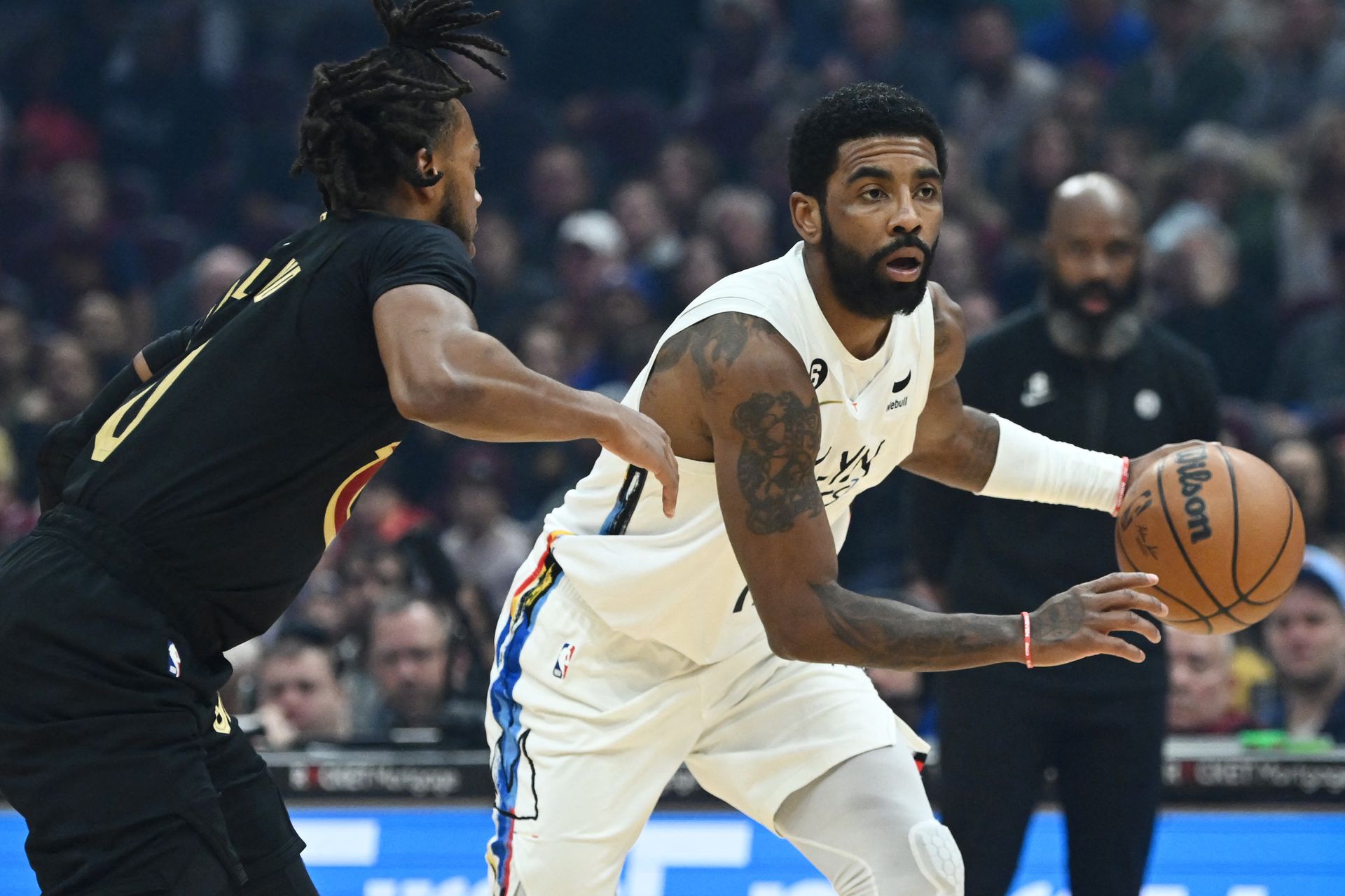 Brooklyn Nets guard Kyrie Irving (11) drives to the basket against Cleveland Cavaliers guard Darius Garland (10) during the first quarter at Rocket Mortgage FieldHouse in Cleveland, Ohio, Dec. 26, 2022.